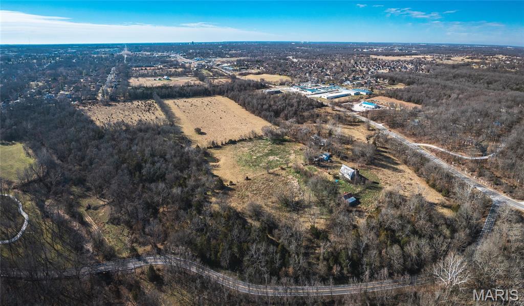 Positioned just outside the Springfield city limits, this 53.66-acre tract represents a rare large-scale development opportunity in one of North Springfield’s expanding growth corridors. Located just minutes north of I-44 with North Glenstone/Highway H bordering the western boundary, the site offers outstanding accessibility, visibility, and proximity to existing infrastructure.

The land features a blend of open pasture and mature timber, providing natural topography well-suited for a thoughtfully designed residential development or other projects. An established neighborhood borders the southern boundary, further supporting the area’s continued residential expansion and subdivision potential.

Large contiguous tracts of this size and location are increasingly scarce. With convenient access to major transportation routes, established neighborhoods, and North Springfield amenities, this offering is ideally positioned for developers, investors, and builders seeking their next strategic project.