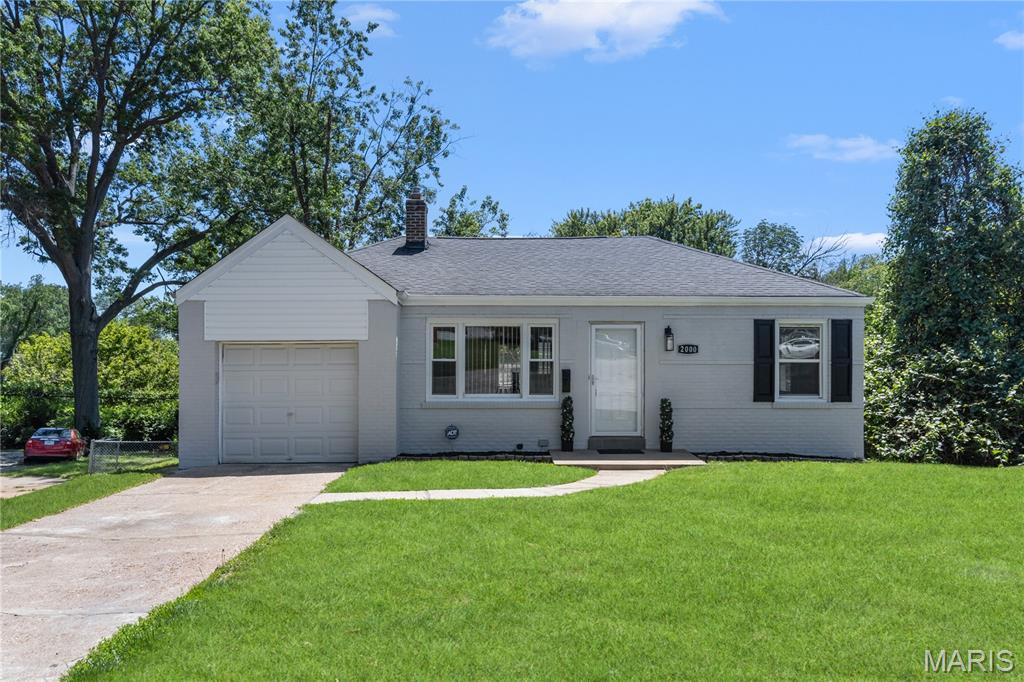 Absolutely charming 2BR, 1BA all-brick home with 1-car garage, finished basement, and bonus room on a large .28-acre lot on desirable street in St. Louis County! Offering over 1,700 sq ft of livable space, this move-in-ready gem has tremendous curb appeal and sits on an amazing cul-de-sac. Step inside to beautiful refinished hardwood floors, large picturesque windows, remarkable hearth fireplace, contemporary lighting, and a custom kitchen featuring subway tile backsplash. The stylish bathroom showcases a ceramic tile tub surround, while major updates include a new roof, newer HVAC, plumbing, electric, and 40-gallon water heater. The finished lower level expands your living space with a spacious recreation area, bonus sleeping room, laundry area, and plenty of storage. Outside, enjoy a humongous backyard and large patio—perfect for entertaining, family gatherings, or relaxing evenings. Conveniently located just minutes from Tharp Civic Center, Koeneman Park, shopping, public transit, and more!