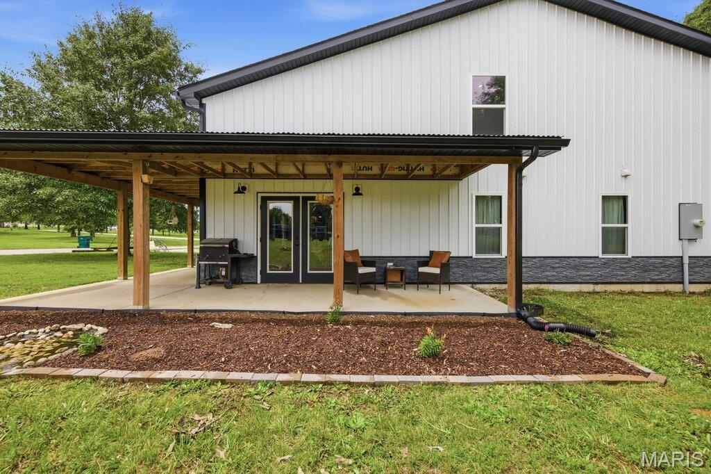 Experience the perfect blend of modern country living and functionality in this custom-built Shouse/Barndominium situated on 3.58 scenic acres with access to a shared pond. Designed with today's sought-after finishes, the 16' tall open-concept floor plan features soaring ceilings, recessed lighting, and spacious living areas ideal for both everyday living and entertaining. Offering approximately 2,400 square feet of living space, the home includes 3 bedrooms, 3 full bathrooms, and two dedicated office spaces. The Open kitchen offers a large island with farm sink & breakfast bar, custom open wood shelves, stainless steel appliances, custom cabinets featuring tons of drawers and a huge walk-in pantry. The main-floor primary suite serves as a private retreat with full bath featuring a freestanding soaking tub, dual vanities, a large custom walk-in shower, and generous closet space.  Upper level offers you tons more living space in the loft, bonus room currently used for home school class time, two more large bedrooms & a full bath.  The attached 1,600-square-foot fully insulated shop provides endless possibilities with THREE overhead doors (Two- 12' with a tandem style/pull through and one 9'), a home office, utility sink, water spigot and additional storage space—perfect for hobbyists, business owners, or those needing extra room for equipment and projects.  French doors lead you to your covered porch to enjoy our outside garden offering pumpkins, strawberries, green bean, corn, watermelon and tons of herbs! Enjoy peaceful country views, modern amenities, and versatile living all in one exceptional property. This unique offering combines the comfort of a custom home with the practicality of a well-designed shop, creating a lifestyle that's hard to find.