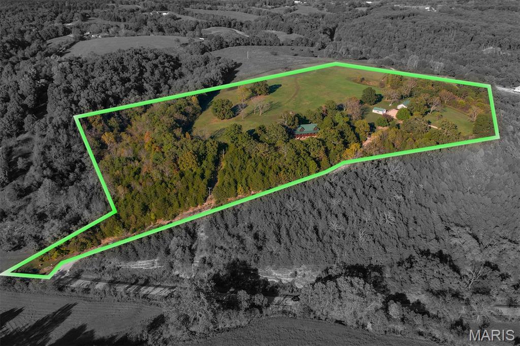 Multi-use acreage estate property featuring a log and guest home. Private and secluded Ozark Mountain paradise located a few miles west of Galena MO in Stone County. The property is located in close proximity to Table Rock Lake, Branson and approximately 45-minute drive to Springfield MO. This multi-home property has approximately 28 acres +/- acres that includes approximately 12 acres +/- of open pasture area that is manicured like a lawn.  An additional 30 +/- adjoining acres comprised of mostly pasture are available for purchase at an additional cost if so desired creating a 58 +/- acre estate.  A small natural pond holds water year around providing a natural source to support livestock and/or wildlife.  The property is extremely private and has a healthy timber mix of oak and black walnut trees.  Privacy features include two points of gated ingress & egress with the back entry road providing for trailered accessibility. This property has so many potential uses its only limited to ones imagination and is a must see.