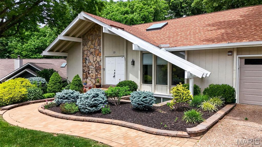Tucked away on a quiet cul-de-sac in Lake St. Louis, this one-of-a-kind ranch offers the perfect blend of warmth, character, and resort-style living. Vaulted ceilings with exposed wood beams create an impressive open living space where the great room, dining area, kitchen, and breakfast room all flow together beautifully. A dramatic floor-to-ceiling stone fireplace anchors the heart of the home while large windows frame the beautifully landscaped backyard and peaceful common ground beyond. Freshly updated with new quartz countertops, backsplash, appliances, and interior paint, this home is move-in ready while still full of charm and personality. The unique floor plan offers exceptional flexibility with 1 main-level bedroom and bath plus 3 spacious bedrooms, full bath, and additional storage/future bedroom space with egress in the walk-out lower level making it ideal for multigenerational living, guests, teens, or work-from-home needs. Enjoy full Lake St. Louis CA amenities including 2 lakes, clubhouse, restaurant, sandy beach, golf, tennis, pickleball, fitness center, and more. Launch your kayak or paddleboard just steps away. Everyday living feels like vacation here.