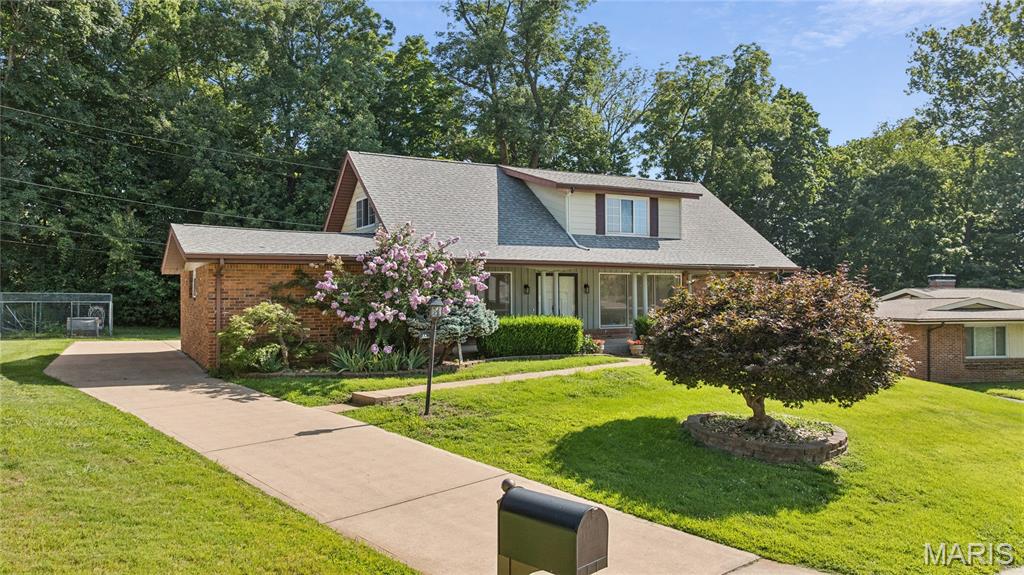 Spacious story-and-a-half home featuring a main-floor primary bedroom suite plus 4 additional bedrooms on the upper level. Hardwood flooring throughout. Full bathroom on each floor. Eat-in kitchen with newer stainless steel appliances and separate dining room. Main-floor family room with gas logs, plus partially finished lower level with recreation room and HUGE storage/workshop area. Newer heating/cooling and water heater, brand new 200-amp electrical service. Oversized 2-car garage. Patio overlooks a spacious backyard. Conveniently located close (but not too close) to Hwy 141 and other major highways. Just minutes from hospitals, restaurants, supermarkets and retail. Parkway Central Schools (Green Trails).