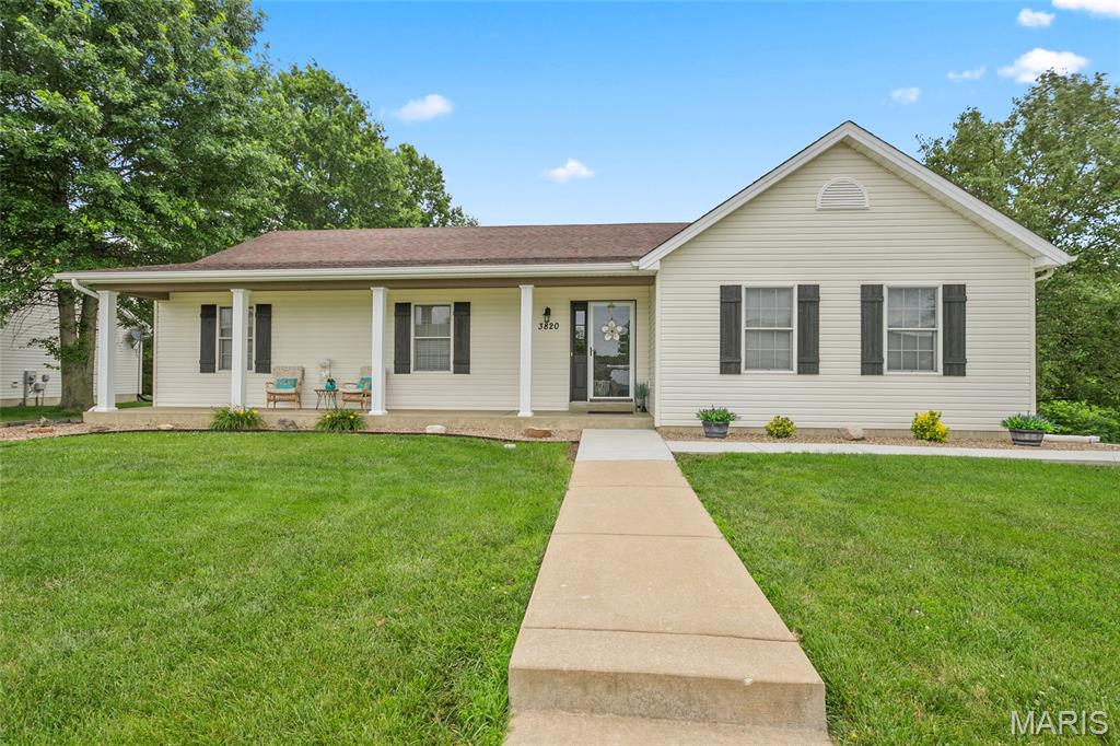 Welcome home to this 4 bedroom, 3 full bath ranch that offers the perfect blend of comfort, space, and privacy. Situated on a desirable corner lot and backing to peaceful woods and open fields, this home provides beautiful views and a serene setting while still offering exceptional convenience. Step back in time and enjoy a slower pace of life while relaxing on the large covered front porch sipping refreshments, and watch the world go by. Inside, you'll find an inviting open floorplan highlighted by soaring vaulted ceilings and abundant natural light. The spacious great room flows into the dining area and kitchen (with Hickory custom cabinetry) creating the ideal space for both everyday living and entertaining. Through the patio doors off the dining area, you'll find an expansive deck providing the perfect setting for outdoor gatherings, grilling, or simply taking in the peaceful view. The main level features a spacious primary suite with a private bath and walk-in closet. You'll also find 2 additional bedrooms, and a hall full bath. Convenient main floor laundry is certainly a plus. The side-entry garage is complemented by an extended driveway, while adjoining a dead-end street, offering ample additional parking for guests and gatherings. The walk-out lower level provides incredible flexibility with a finished 4th bedroom, full bath, and a walk-in closet big enough for royalty. There is also substantial partially finished space that's ready for your personal touch...perfect for additional living space, including a 28' x 16' covered patio. With it's desirable scenic setting, generous living area, and room to grow, this home delivers the lifestyle today's buyers are searching for. Don't miss this opportunity!!   NOTE:  A few of the pictures have been virtually staged to show the possibilities for future living areas in the partially finished lower level.