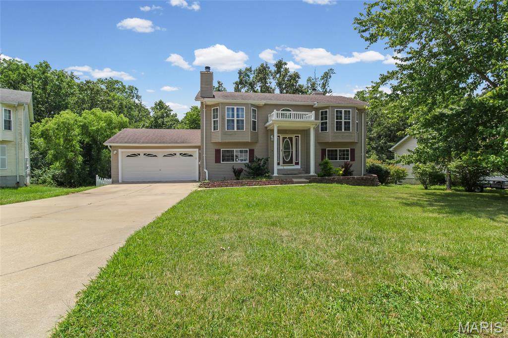 Tucked away on a quiet cul-de-sac, this spacious 3-bedroom, 2-bath home offers over 2,000 square feet of comfortable living space with a layout designed for both everyday living and entertaining.

Step inside to an open-concept main level featuring vaulted ceilings, abundant natural light, and a cozy fireplace that creates the perfect gathering space. The primary suite is a true retreat with its own fireplace, walk-in closet, and private bath complete with a whirlpool tub and separate shower.

The finished walk-out lower level provides two additional bedrooms, a full bath, and generous flex space ideal for a family room, game room, home office, or gym. Enjoy morning coffee or evening sunsets from the upper deck overlooking the fenced backyard that backs to peaceful woods and a creek, offering added privacy and a beautiful natural setting.

Conveniently located near schools, parks, shopping, and dining, this move-in-ready home combines small-town charm with modern comfort. If you've been searching for space, privacy, and a home that feels warm and welcoming from the moment you walk in, this one is a must-see!
