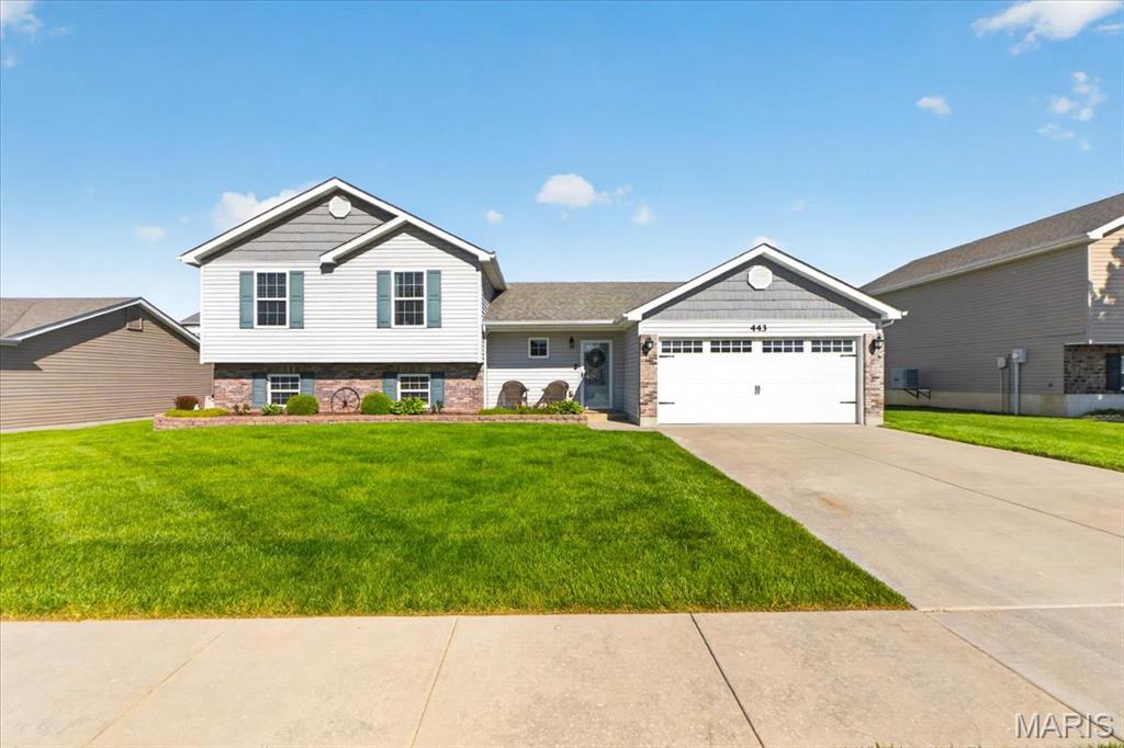 Welcome home to this beautifully updated 3 bed, 2 bath multi-level home in the heart of Wentzville! From the moment you arrive, you’ll love the curb appeal, spacious 2 car garage, and inviting covered front porch. Inside, the open floor plan offers vaulted ceilings, updated flooring, and a bright, airy living room featuring a stunning stone electric fireplace and shiplap accent wall. The kitchen is a showstopper with granite countertops, stainless steel appliances, custom backsplash, and abundant cabinetry perfect for gathering and entertaining. The spacious primary suite, two secondary bedrooms and second full updated bath complete the upper level. Step outside to your backyard oasis complete with an expansive stamped concrete patio, pergola, fenced yard, storage shed, and above ground pool—perfect for relaxing or hosting all summer long! Conveniently located near schools, parks, shopping, restaurants, and easy highway access, this move-in ready home truly has it all!