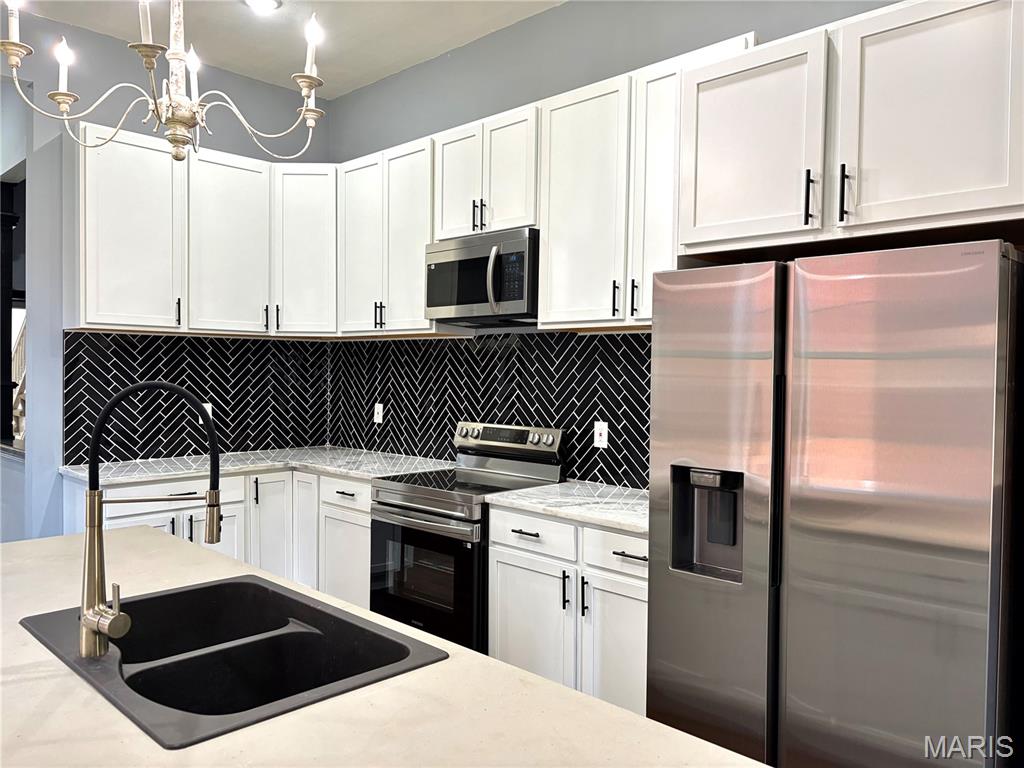 This three-story historic home in the vibrant McKinley neighborhood of St. Louis offers a perfectly blended experience of 19th-century charm; a timeless appeal and modern functional living in this beautifully refreshed home. Located in one of the city's oldest and most historic districts, this 3-bedroom, 2.5-bathroom residence captures the essence of urban living just minutes from the highway, Tower Grove Park, Lafayette Park, and the historical Soulard. The heart of the first floor features main floor laundry hook ups, gorgeous original fireplace, brand new stainless steel appliances, including a stove, double door fridge, double sink in island, paired with ample cabinet space for all your culinary needs. The second floor features an in suite spacious bathroom, walk in closet, and all three bedrooms. The third floor's possibilities are endless. You've got a completely open level to do with as you wish. From the extraordinary walk-in ceramic tile shower to the spacious bedrooms, capped with high ceilings, come make this house a home.