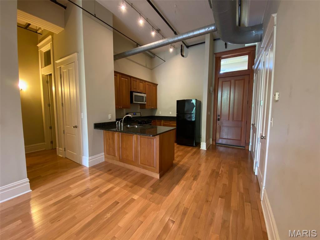 History. Character. Tower Grove Park out your front door and a remarkable view from your Loft.  This remarkable condo conversion puts a fresh, contemporary twist on a former police station, marrying timeless architecture with refined living. Step inside to find impressive 12-foot ceilings, warm hardwood floors, and a front-row view of the vibrant greenery of Tower Grove Park right across the street. The kitchen strikes the perfect balance of style and function with 42-inch cabinets, granite countertops, and a gas stove. The generous bathroom offers relaxation with a jetted tub. Stacked washer/dryer included for everyday convenience. The building also offers added lifestyle amenities, including bike storage and a large maintenance free deck, perfect for enjoying the views and the beauty of the park just steps away. Located at the front entrance of 2800 S Grand, with a tax record address of 3556 Magnolia Avenue, Suite 202, you are right in the heart of it all with easy access to parks, restaurants, hospitals, highways, and everything the City has to offer. This is more than a place to live, it is a lifestyle.   Now is the time to own a piece of St. Louis history where distinctive architectural character and modern finishes come together for a truly exceptional living experience.