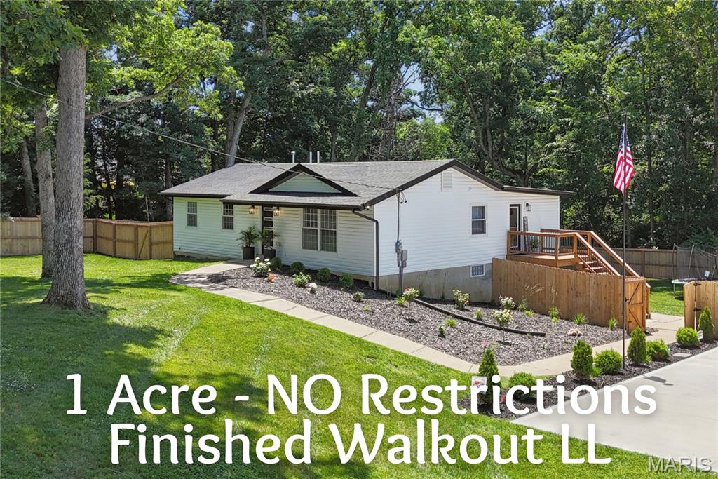Wonderfully Unique Property On One Acre Lot With “NO” Subdivision Restrictions! This true gem has been updated and remodeled from top to bottom! The open floor plan greets you at the front door with lovely laminate wood flooring though out main level and lots of recessed lighting! The kitchen has large center island with black/white quartz counters and nice Rattan pendant lights! Upgraded white cabinets with crown mold, stainless appliances, gas cooktop with decorative hood, built in oven and microwave, pantry plus tile backsplash! Mud room and main floor laundry off back door! The primary bedroom has a walk in closet and private bath with stunning walk in shower! Two other nice size bedrooms and 2nd full bath completes the main level! The finished walkout lower level features large family room, 3rd full bath and 4th bedroom plus storage! Large deck and covered epoxy patio plus fenced in yard!! Parking pad large enough for 4 cars! Awesome location close to everything!!