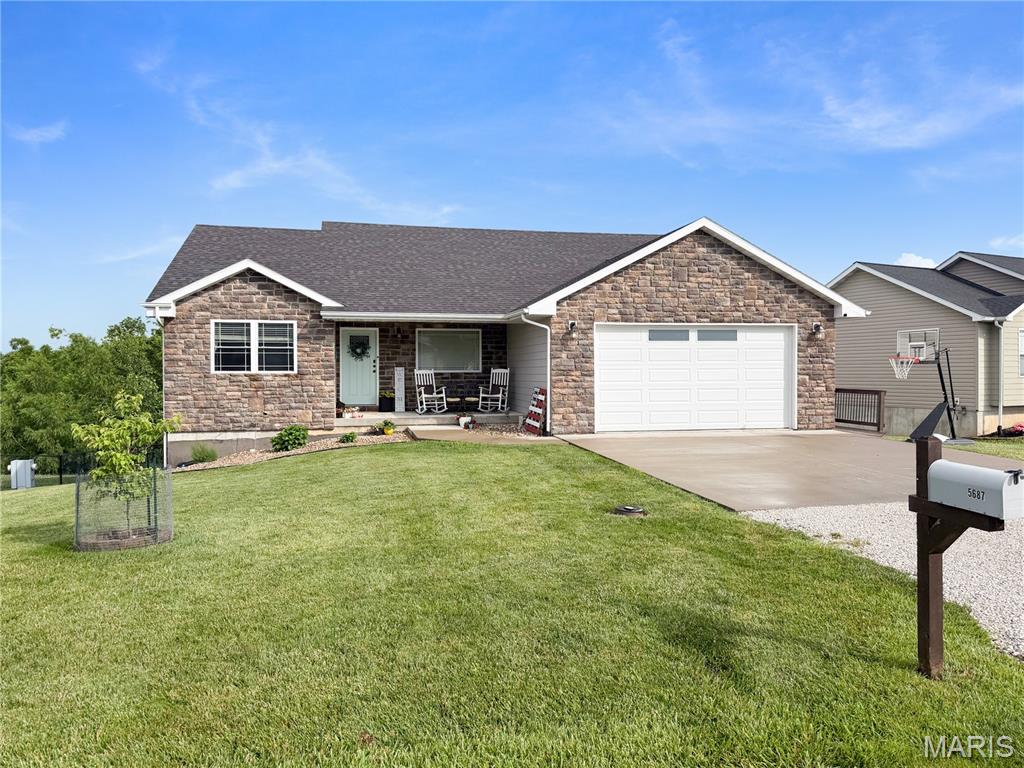 Built in 2018, this stunning ranch-style home offers the perfect blend of modern design, quality finishes, and functional living space. Featuring 3 bedrooms, 3 full bathrooms, and nearly 2,927 finished square feet (1,562 on the main level and 1,365 in the finished walkout lower level), this home has room for everyone to spread out and enjoy. Situated Clear Creek Subdivision, conveniently located just outside of town. 
Step inside to an inviting open-concept floor plan highlighted by vaulted ceilings, rich flooring, exposed wood beam accents, and an abundance of natural light. The spacious kitchen is designed for both everyday living and entertaining, offering ample cabinetry, generous counter space, a large breakfast bar, and seamless flow into the dining and living areas. The main-level primary suite provides a private retreat with an ensuite bath and walk-in closet.
The finished lower level is an entertainer's dream, featuring a custom wet bar, expansive family room, recreation space, and a versatile bonus room perfect for a playroom, home office, fitness area, or hobby room.
Outside, enjoy peaceful mornings and relaxing evenings on the elevated deck overlooking the fully fenced backyard. The attractive stone-accent exterior, covered front porch, and desirable neighborhood setting add to this home's exceptional curb appeal.
Modern, spacious, and move-in ready—this beautifully maintained Clear Creek home is one you won't want to miss.