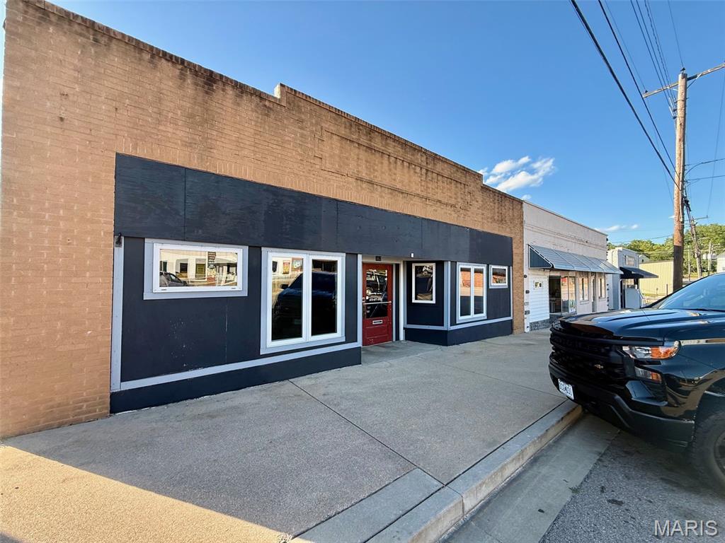 Prime downtown Bourbon storefront — 2,476 ± SF adaptable retail space ideal for boutique, café, restaurant, antique shop or other retail concepts. Bright open-concept floorplan with large display windows, small commercial kitchen, two restrooms, updated systems, and flexible layout for immediate build-out. High-visibility location in the heart of downtown with strong pedestrian traffic and nearby amenities. Zoned for commercial use; turnkey opportunity or ready for tenant improvement.