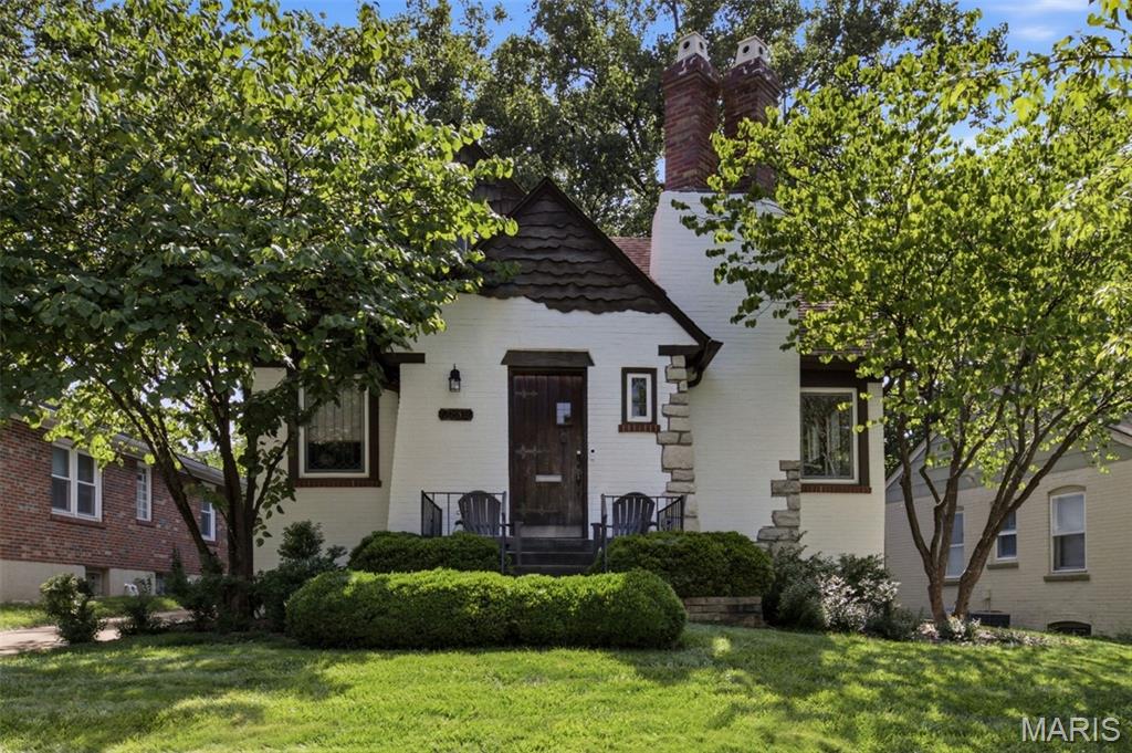 I honestly don't think you can find a cuter 1 1/2 story cottage home in Richmond Heights than this! With it's Hansel and Gretel style architecture, the stucco, stone brick and wood create a dreamy house you now have a chance to call home. Boasting 3+ total bedrooms, 2 full bathrooms, separate dining, a lovely sun room and around 1600 sq ft, there's plenty of space to make this your own. Upon entering the front castle-like foyer, you'll step into the main living room with its original fireplace, currently set up with gas logs, along with original coved ceilings, trim work and hardwood flooring throughout. The separate dining room flows into the kitchen. The first floor features 2 bedrooms, one with a very cool coffered beam ceiling, and a full bathroom. Upstairs is a large room and bedroom, along with it's own full bathroom with separate shower. You'll love sitting in the attached sunroom off the back of the house. And out back, you have a yard with lots of shade, and a detached 1 car garage with additional covered parking, allowing you to fit 2 cars tandem. This house is just so adorable inside and out, don't wait; schedule a showing ASAP! OPEN HOUSE Sunday 7/5 1-3pm.