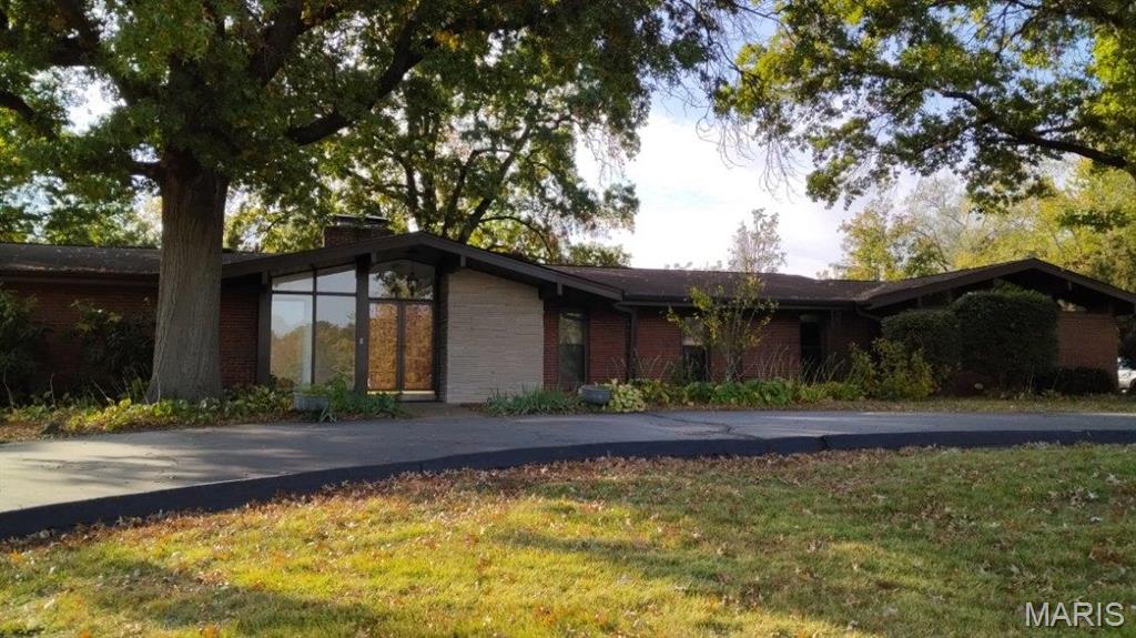 Updated ranch in Ladue Schools with circular drive that looks directly out, front and center, to Venable Park. The main level floor plan consists of large entry foyer leading to vaulted windows in living, dining and family room, three bedrooms and two full baths w/primary suite. Huge custom kitchen has island, granite and stainless appliances with full Maple cabinets. Fresh, agreeable interior paint colors and luxury vinyl plank flooring throughout. Finished lower level fitness room AND office has full bath. Wonderful natural light combined with closets galore creates total comfort. Kitchen and family room share slider walkout to large patio /deck for outdoor pleasure and fun . With well over 2000 square feet on the main level plus a two car garage, this home provides all the essentials.
