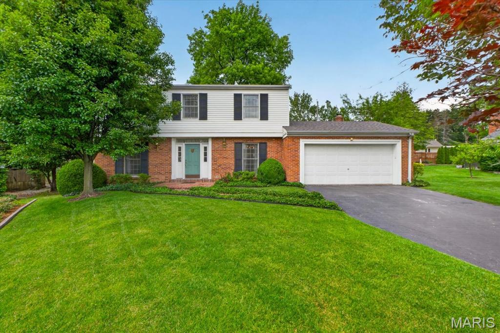 Welcome to this charming Ladue gem nestled on a quiet cul-de-sac, just steps from the shops and dining along Clayton Road, and to Conway Elementary and Ladue Middle School.  Perfectly situated in a central location with easy access to everything St. Louis has to offer, this 3-bedroom, 2.5-bath, two-story home combines timeless character with everyday comfort.
Warm wood and parquet floors highlight much of the main level, while both the living room and family room feature inviting gas fireplaces—ideal for relaxing evenings. The family room also offers custom-built-in bookcases, boxed ceiling, and glass doors that open to a private, beautifully landscaped backyard and patio, creating a seamless indoor-outdoor living experience.
The kitchen is designed for both function and convenience, complete with a pantry, double ovens, and a nearby half bath for guests. Upstairs, all three bedrooms have wood floors beneath the carpet and generous closet space, with two bedrooms featuring sizable walk-in closets. An additional walk-in closet in the hallway provides exceptional storage.
The primary suite includes a fireplace, a walk-in closet, and an ensuite bath. Another full hall bath serves the remaining bedrooms. The unfinished basement offers endless potential for future living space and abundant storage.
Additional highlights include a new roof (2025) and an HVAC system less than 10 years old.
Enjoy the opportunity to make this well-located, character-filled home your own in one of Ladue’s most sought-after areas.