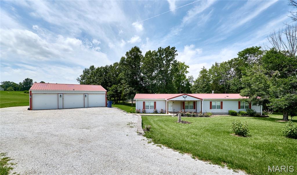 Spacious 3 bdrm 2 bath home on 2 acres in southern Lincoln County with 3 car detached garage plus a 30X40 barn with lean to-huge covered back deck overlooks park like setting with woods yet some open ground-home features living room with hardwood floors, family room with w/b fireplace, formal dining area and huge master suite with luxury bath-sitting on concrete block foundation with poured concrete footing-call before this one is gone-Convenient location south of Troy