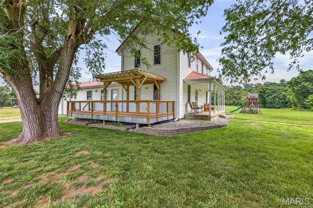 Looking for the charm of country living without the demands of maintaining a farm? This inviting property offers the best of both worlds. Conveniently located less than a mile from I-55, the home sits on approximately 0.7 acres next to a peaceful working crop farm, with expansive views of surrounding fields in every direction. Outdoor living is a highlight, with three separate porches providing plenty of places to relax and take in the scenery. The covered rear porch and swimming pool create the perfect setting for enjoying sunsets and wide-open views. Inside, you'll find a spacious layout featuring 3 bedrooms and 3 full bathrooms. The kitchen is equipped with bamboo flooring, solid-surface countertops, stainless steel appliances, a subway tile backsplash, and timeless shaker-style cabinetry. Just off the kitchen and dining area, the comfortable living room features built-in shelving and beadboard ceilings. A generously sized main-floor laundry room offers flexibility for additional storage, hobbies, or even a home fitness space. Downstairs, the finished lower level includes a second living area, kitchenette, laundry hookups, and direct access to the garage—ideal for guests, multi-generational living, or added convenience. The oversized two-car garage features high ceilings and an extended bay that provides ample room for a workshop or extra storage. Properties with this combination of location, views, and versatility don't come along often, schedule your showing today!