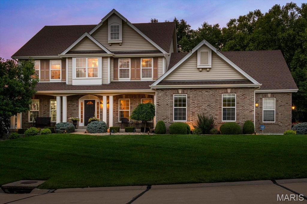 Welcome to 9031 Spy Glass Place Drive, an exceptional custom 1.5-story home complete with a 3 car side entry garage, tucked away on a homesite in the prestigious Villages at Spy Glass Hills in Winghaven. Thoughtfully designed with timeless architecture, refined finishes, and expansive living spaces, this stunning home offers 4 bedrooms, 3.5 bathrooms and an outdoor oasis. The gourmet Chef's Kitchen is designed to inspire both everyday living and effortless entertaining. Custom cabinetry is complemented by granite countertops, decorative tile backsplash, premium stainless steel appliances, a gas range and an oversized center island. A butler's pantry provides additional prep and serving space, while the built-in planning desk offers the perfect command center. Just beyond the kitchen, the Breakfast Nook and sun-filled Hearth Room,  surrounded by windows, capture the peaceful backyard views. The Great Room creates an unforgettable first impression with its wall of windows, custom built-in bookcases, and elegant fireplace. This space offers the perfect balance of sophistication and comfort while showcasing the landscaped yard. The main-level Primary Suite is a private sanctuary complemented by a custom walk-in closet system and a spa-inspired luxury bath. The updated bathroom features a freestanding soaking tub, an oversized walk-in tile shower, dual granite-topped vanities, designer lighting, and an elegant decorative tile backsplash. A private suite on the upper level features its own en-suite bath and designer walk-in closet, while Bedroom #3 and #4 share a spacious Jack-and-Jill bathroom, offering comfort and privacy. The Loft/Bonus Room offers flexible recreation space. Outdoor living is equally impressive. Step onto the patio overlooking a beautifully landscaped backyard complete with a tranquil koi pond, inviting firepit, and a canopy of mature trees that provide exceptional privacy and a peaceful setting. This home is just minutes from the exclusive WingHaven Country Club, where residents have the opportunity to enjoy private golf and social memberships. Experience championship golf at a Jack Nicklaus designed golf course, exceptional dining, resort-style swimming, tennis, pickleball, fitness amenities, and social events—all just moments from your doorstep. With its exceptional craftsmanship, thoughtfully designed floor plan, luxurious finishes, and ideal location, this remarkable home delivers the perfect blend of elegance, comfort, and everyday livability.