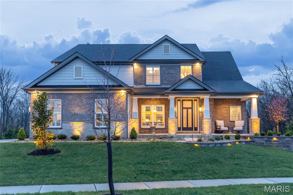 With over $500,000 in improvements since new construction, this home offers exceptional value in a premier West St. Louis County location! This spectacular 1.5-story home showcases an open floor plan with soaring ceilings, extensive millwork, and oak hardwood floors throughout the main living areas. A dramatic two-story entry foyer welcomes you, leading to a beautifully appointed dining room and a stunning great room featuring a marble fireplace and a wall of windows overlooking serene, wooded grounds. The designer kitchen is a true centerpiece, offering burlap cabinetry, Cambria quartz countertops, Café appliances, and a 7-foot center island. It seamlessly connects to a light-filled breakfast room and a cozy hearth room with a charming brick fireplace. The spacious primary suite serves as a private retreat, complete with a wide bay window and a luxurious bath featuring an expanded spa-like shower. An open staircase leads to the upper level, where you’ll find three additional bedroom -one with an ensuite bath, two connected by a Jack-and-Jill bath—as well as a versatile bonus room. The finished lower level boasts a large recreation room, fifth bedroom, and full bath. Outdoor living is exceptional, featuring a large maintenance-free deck with a Dry-B-Low rain guard system, a spacious covered paver patio, a fenced level lot, and a dedicated dog run. The property is enhanced by extensive professional landscaping and lighting by Elevate Outdoor. Additional highlights include a climatized, finished three-car garage. Residents of Tara Ridge enjoy exceptional community amenities, including a pickleball court, butterfly garden, playground, pavilion, and a charming community library box.