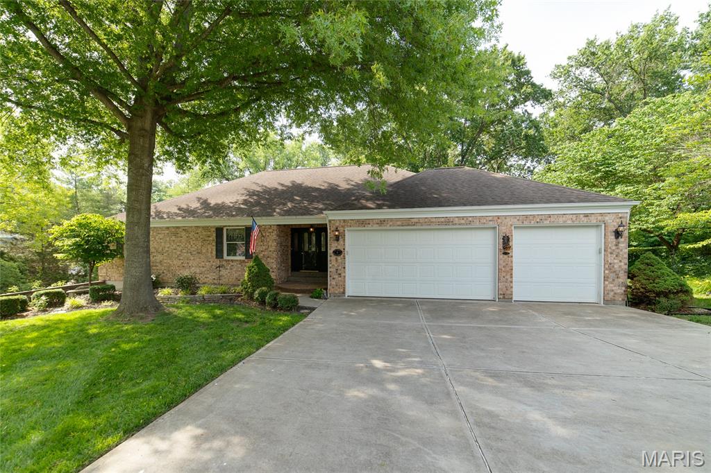 Welcome to this stunning 4-bedroom, 3-bath Atrium Ranch home with over 3700 sq ft of Living Space that is perfectly blended with a classic elegance with modern convenience. Boasting a beautiful brick facade and exceptional curb appeal, this spacious residence is situated on a prime lot that backs to scenic, private woods. Ideal for both daily relaxation and seamless entertaining this property offers an expansive layout and thoughtful structural upgrades. The Large Great Room features gleaming wood flooring and a magnificent, masonry gas fireplace as its central focal point. The Open Atrium Floods the living space with natural light while offering architectural depth and looking down into the lower level. The Kitchen is outfitted with timeless oak cabinetry and premium granite countertops. A Sunlit 4-Season Room located just off the kitchen, provides a versatile        year-round retreat with peaceful views of the wooded backdrop. The Main Floor Laundry is positioned perfectly for maximum day-to-day convenience. The tranquil primary bedroom is designed as a private sanctuary. The En-Suite Bath includes a dedicated, private bathroom space for ultimate comfort. There is Deck access just steps away to a private deck overlooking the large yard. The Large Lower Level includes a Gas Fireplace, Wet Bar, Entertainment Area, additional Bedroom And a quiet, dedicated office space tucked away for remote work with French Doors. The Entertainer’s Backyard is large with an open yard featuring an expansive stamped concrete patio designed for hosting BBQs and outdoor gatherings. There is Ample Parking with an attached 3-car garage that offers extensive vehicle parking and storage solutions. Don't Miss this Beautiful Home!