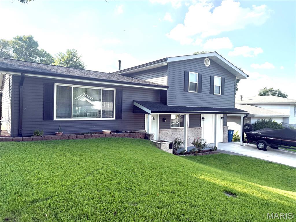Nestled in the heart of South County (Melville area), this beautifully updated 3-bedroom multi-split-level home offers the perfect blend of modern style, functional space, and peace of mind. Step inside to the main floor and be greeted by a  open floor plan designed for modern living. The spacious living and dining rooms feature  laminate wood floors and are flooded with natural light. The kitchen is fully equipped with a newer dishwasher and range,  complemented by  ceramic tile flooring. The Upper Level features three generous bedrooms, each freshly updated with brand-new flooring, and updated bathroom. The Walk-Out Lower Level features a massive asset to the home, featuring a spacious family room anchored by a cozy wood-burning fireplace. This level also includes a convenient laundry area, a half bathroom, and direct walk-out access to the backyard, transitioning  from the indoors straight onto a spacious concrete patio. Framed by an elegant retaining wall, this expansive patio area is tailor-made for a fire pit, patio set, or container garden. The entire yard is fully fenced. Tucked in the corner is a practical storage shed to keep your outdoor space clutter-free.