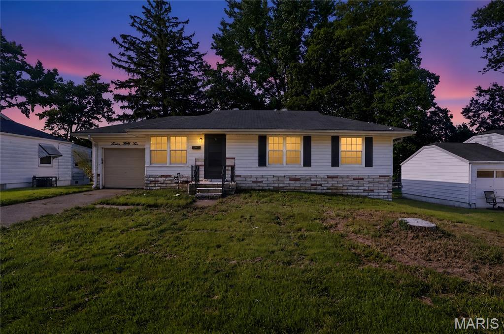 Discover comfort and convenience in this charming 3-bedroom, 1-bath traditional ranch located in St. Louis. Featuring an inviting main-level layout, this home includes a functional kitchen, cozy dining area, and hardwood-topped living spaces filled with natural light. The property offers a full basement with washer/dryer hookups, an attached 1-car garage, and a private driveway. Situated on a manageable suburban lot within the Riverview Gardens school district, this delightful residence delivers incredible potential and classic appeal.