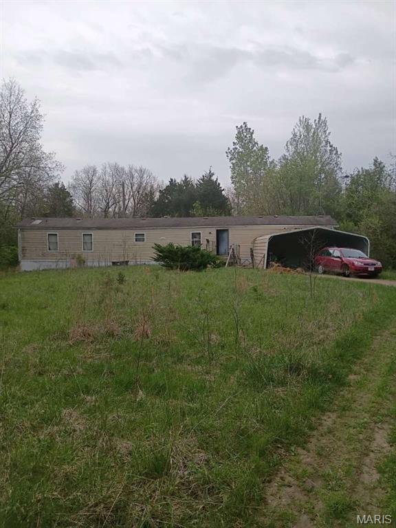 Situated on 3.2 acres, this 3 bed, 2 bath manufactured home offers a great opportunity for an investor, flipper, or buyer looking for land and potential. Built in 1996, the property features a private setting with room to expand, a carport, small shed and septic already in place. The home will require significant repairs and updating throughout and is being sold as-is. If you’ve been looking for acreage with utilities already established, this could be the opportunity you’ve been waiting for.