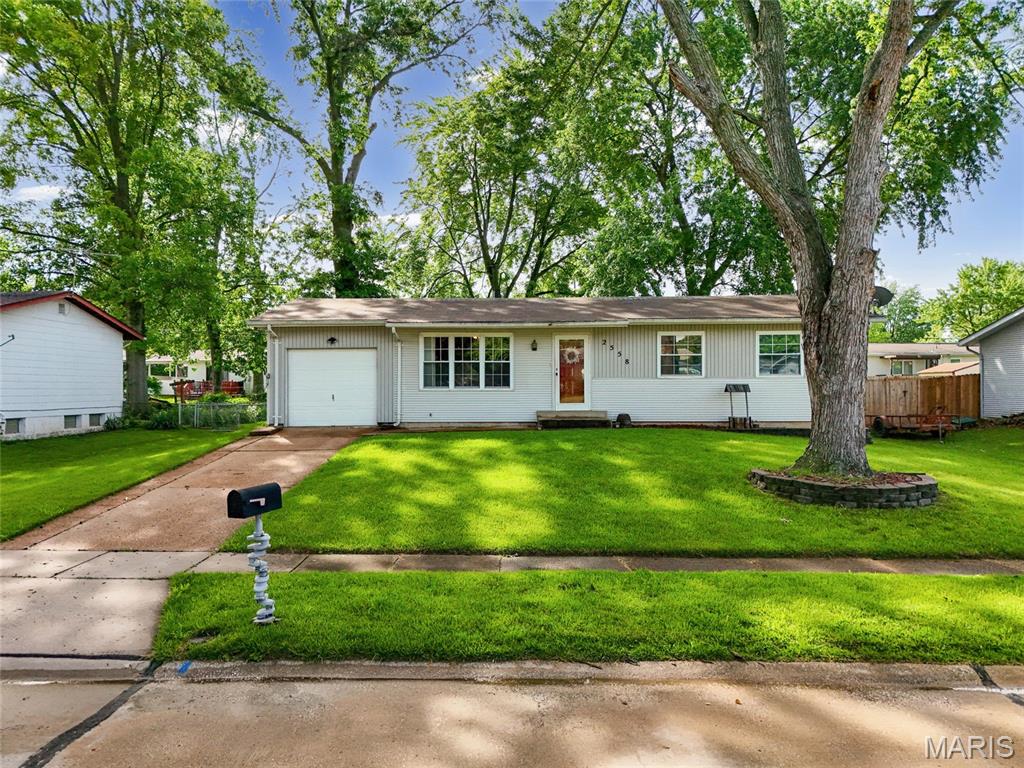 WOW - Outstanding opportunity!! Great curb appeal leads you to the inside of this beautiful home. Lots of natural sunlight through the big front window & beautiful hardwood flooring as you enter the spacious living area. The big kitchen offers lots of cabinetry, gas range & dishwasher and opens up to the dining area. There are three great sized bedrooms on the main level and an updated bathroom. Downstairs there’s a fully usable lower level with a large recreation/ family room with a fireplace, a full bath and a bonus room - could be another sleeping room, office, gym/ workout space+++ Separate utility/ laundry room for extra storage. A large deck off the kitchen overlooks your fully fenced-in, level backyard. Convenient attached oversized, one car garage with additional room for storage. Move-In Ready for you - comes with a passed occupancy! Location, location - tucked away in a quiet neighborhood, yet close to all highways, schools, parks, shopping & restaurants. Easy access to St Louis City, STL airport and more. CALL NOW