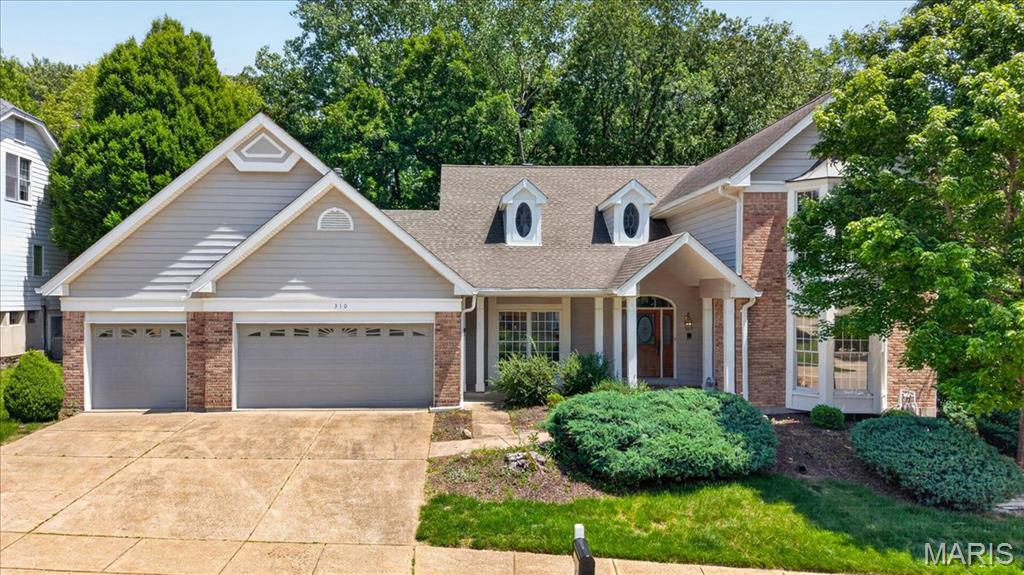 Tucked away on a quiet cul de sac in the heart of Wildwood, this beautifully maintained 1.5-story home offers 4,274 sq ft of thoughtfully designed living space that blends warmth, functionality, and the kind of inviting spaces buyers are searching for. With 4 bedrooms, 3 full bathrooms, and 1 half bath, the layout offers the perfect balance of everyday comfort and room to grow.

Step inside to a welcoming front foyer with tall ceilings that immediately create an open and airy feel. The main level features hardwood flooring, main floor laundry, and a spacious kitchen with a cozy sitting area that naturally becomes the heart of the home. Just beyond, the great room offers a gas log fireplace and an entrance that opens to the enclosed back porch, creating a seamless space for gathering, relaxing, or hosting friends and family. The main floor primary suite adds convenience and privacy, while the upstairs bedrooms provide comfortable spaces for everyone.

The finished lower level offers incredible flexibility with a large recreation area, full bathroom, two additional rooms ideal for an office, gym, guest space, or playroom, plus plenty of storage.

Step outside and you will immediately understand what makes this home special. Whether you are enjoying slow mornings on the covered front porch, entertaining on the tiled patio, or unwinding in the private backyard, every space feels designed for making memories. Homes with this much character, warmth, and usable living space rarely come available in such a desirable cul de sac setting.