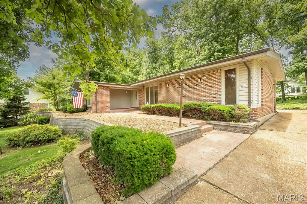 Welcome home to this charming 5 bedroom, 3 bath ranch in desirable Claymont Subdivision. The main level features entry foyer, wood flooring, formal living and dining rooms, a vaulted great room with stone gas fireplace and wet bar with access to the back patio. Spacious kitchen with granite countertops, breakfast bar, pantry and breakfast room. Four bedrooms are located on the main level, including a primary suite with access to the all-seasons sunroom overlooking the mature tree-lined backyard. The walk-out lower level offers a large entertaining area complete with bar, fifth bedroom, full bath, bonus room and workshop/hobby room. Irrigation system in both front and side yard. Newer AC (2023) and Furnace (2022). Living room and bedrooms have hardwood underneath the carpet just waiting to be finished. Laundry hookups located in primary bedroom as well as the basement for desired convenience. Situated on an oversized lot and conveniently located within walking distance of Claymont Elementary School and just minutes from Ballwin’s North Point Aquatic Center and Ballwin Golf Course. Must see! Property is part of an estate. Home to be sold AS IS. Occupancy will not be provided.