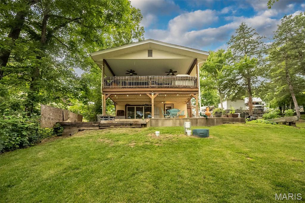 Wake up to peaceful lake views and end the day with spectacular sunsets from your own private dock. Nestled among mature trees, this inviting waterfront retreat offers the perfect blend of comfort, relaxation, and year-round lake living. The main level features an updated kitchen, two bedrooms, full bath, and walls of windows that bring the outdoors in, while the walk-out lower level offers a second kitchen, family room, and additional full bath.
Outside is where this property truly shines! Enjoy morning coffee or evening cocktails from the expansive covered deck overlooking the water, gather with friends beneath the enormous covered patio, roast marshmallows around the firepit, or spend the day fishing from your private dock. Ample off-street parking provides plenty of room for visitors and even accommodates an RV, making weekend gatherings effortless.  Life's better when your backyard ends at the water!