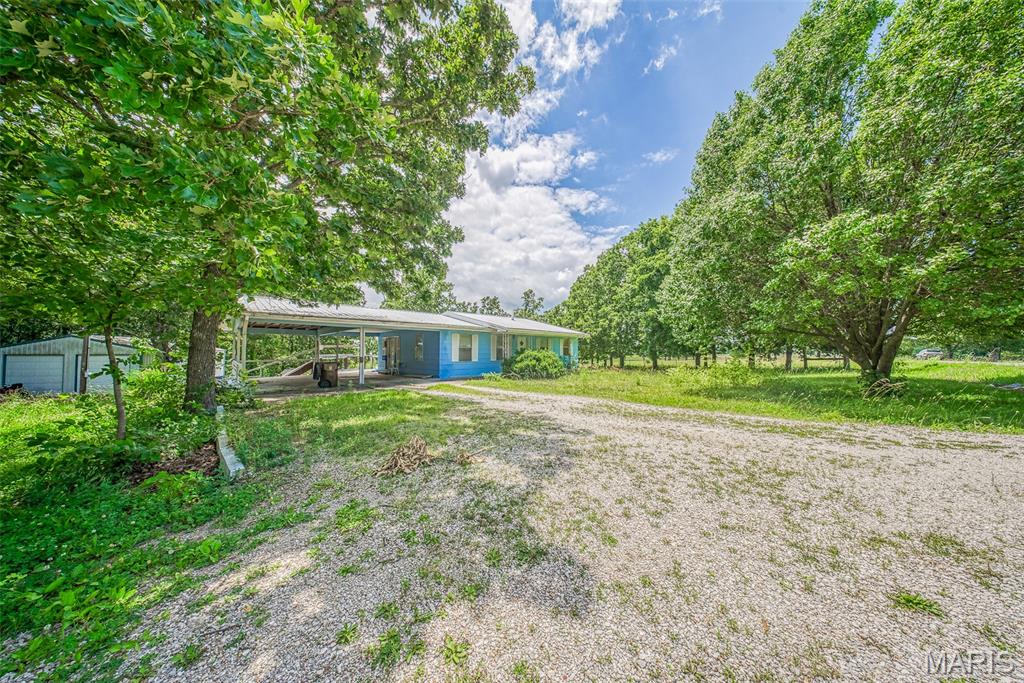 Great opportunity awaits with this 2-bedroom, 1-bathroom home situated on almost 2 acres in Davisville! Offering a peaceful setting with a pond on the property, this home has plenty of potential for an investor, first-time buyer, or anyone looking to add their personal touch. Inside, you’ll find a generous living room, a large eat-in kitchen with abundant space for gatherings, and a bathroom featuring a double vanity. The home also includes a full unfinished walk-out basement providing excellent storage or future expansion possibilities. Outside, enjoy the convenience of an attached 2-car carport, detached garage, and ample room to roam. Don’t miss this great investment opportunity with country charm and endless possibilities! Schedule your private tour soon.