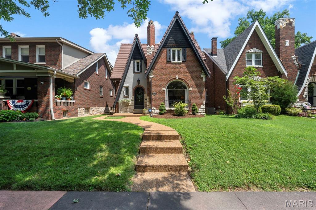 Storybook Tudor charm just steps from Francis Park. Welcome to picturesque 5843 Itaska Street, a great opportunity to put down roots in one of St. Louis’ most beloved neighborhoods. Ideally situated just 1.5 blocks from Francis Park, this classic 3-bedroom, 1.5-bath Tudor is brimming with the timeless character and architectural details that make St. Louis Hills so special.

From the moment you arrive, you'll be captivated by the home's enchanting curb appeal. A rounded front door, charming front porch, stained-glass windows, and a flower box create the perfect storybook welcome.
Inside, a gracious formal living room showcases 9-foot ceilings, a beautiful fireplace, and a stunning arched picture window that fills the space with natural light. The separate dining room is ideal for entertaining and flows seamlessly into both the kitchen and family room.
Designed for everyday living, the spacious family room invites you to relax and unwind with vaulted ceilings, recessed lighting, and a second fireplace—the perfect setting for movie nights or gathering with friends and family. The kitchen blends vintage charm with functionality, featuring classic Vitrolite tile walls, a generous pantry, and a peninsula overlooking the family room, creating an ideal spot for casual breakfasts, homework sessions, or serving guests during game-day celebrations. A striking powder room adorned with dramatic black Vitrolite walls completes the main level.
Upstairs, you'll find a comfortable primary bedroom with a walk-in closet, two additional bedrooms, and an updated full bath.Recent updates provide peace of mind and include dual HVAC systems, a new water heater (2025), and updated plumbing and electrical systems.

Beyond the front door, enjoy one of St. Louis' most walkable and vibrant lifestyles. Whether you're meeting friends at Francis Park, grabbing coffee, picking up donuts, enjoying a famous sandwich, or treating yourself to Ted Drewes frozen custard, some of the city's favorite local destinations are just a short stroll away.
Classic architecture, modern updates, and an unbeatable location—5843 Itaska Street is the St. Louis Hills home you've been waiting for.