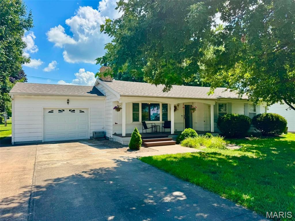 The 3-bed, 2-bath, move-in-ready masterpiece of a home you've been waiting to plant roots in has arrived! Welcome to 311 Meadow Dr where you are greeted by instant curb appeal and knocked off your feet by the massive living room and real wood-burning fireplace after stepping inside. Get back on your feet to explore the rest of the home including: a primary bedroom with half bath ensuite, 2 additional specious bedrooms, and a full bath with wainscoted walls that will make you want to visit the bathroom more often that you should! The kitchen/dining combo provides plenty of space for sit-down dining, enough counterspace for company, and connection for your attached garage full of storage options. Like what you see? We aren't finished. Out back you can find a massive concrete patio, partially fenced yard, and enough privacy for a private eye to wonder what's going on. Don't wait; this is an in-person, must-see property!