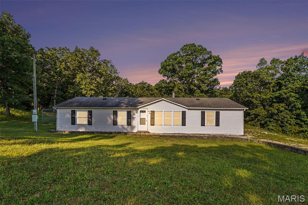 Nestled on a peaceful private street, this well-maintained manufactured home sits on a spacious 1-acre lot and offers the perfect blend of comfort and privacy. Inside, you'll find 3 bedrooms, 2 full bathrooms, a large kitchen with plenty of cabinet and counter space, and a cozy wood-burning fireplace that's perfect for relaxing evenings at home. Step outside to enjoy the large fenced backyard, ideal for pets, play, gardening, or entertaining. With plenty of room to spread out both inside and out, this property offers country-style living while still being conveniently located near everyday amenities. Don't miss your opportunity to own this private retreat with space to enjoy and make your own!