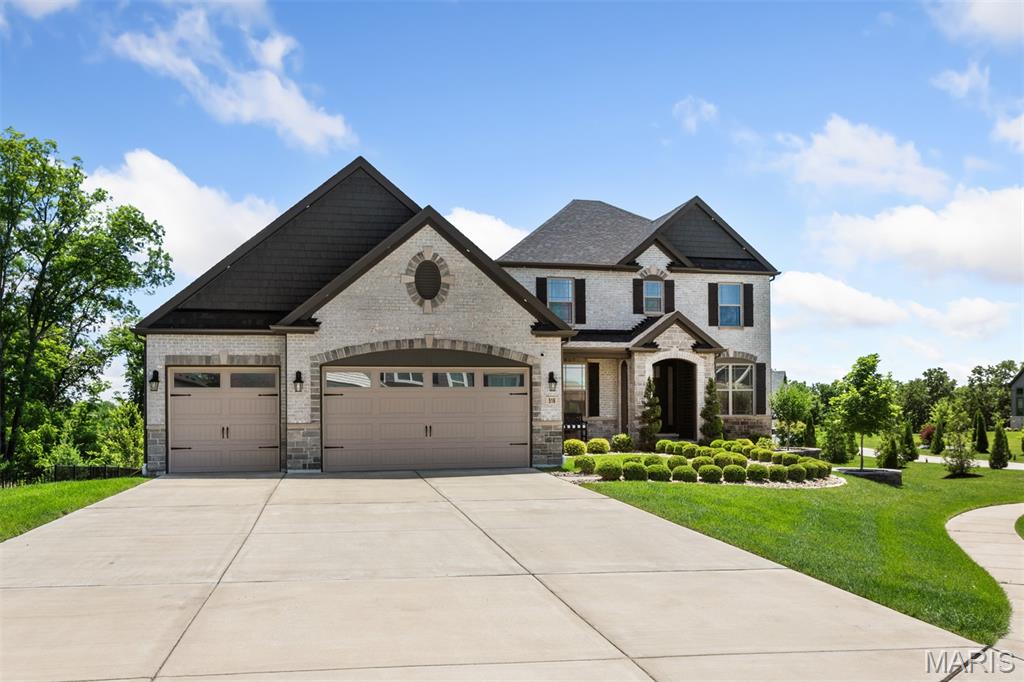 Welcome to this beautifully appointed 1.5 story home offering the perfect blend of comfort, sophistication, and breathtaking surroundings. Built by Lombardo Homes in 2021, the thoughtful and intentional upgrades chosen during the building process make this home a dream for any buyer. Step inside to discover a warm and inviting entry foyer, flanked by the expansive dining room on one side and office on the other with 8-foot French doors for added privacy. Entertain in style in the formal dining room, enhanced by a tray ceiling and a stunning chandelier. The great room is highlighted by a cozy gas fireplace and a dramatic two-story window wall that fills the home with natural light while perfectly framing the incredible views. The heart of the home is the upgraded chef’s kitchen, complete with a standout stone arch feature above the built-in 5 burner gas cooktop, a Frigidaire Professional refrigerator and freezer, Frigidaire Gallery double wall ovens, quartz countertops, under cabinet LED lighting, a 36-inch apron front sink, a walk-in pantry, and 42-inch cabinets with additional glass-front cabinets above. The primary suite is discreetly tucked away on the main level and features an upgraded sitting room, two massive walk-in closets with custom organization systems and an upgraded luxury primary bathroom with a freestanding bathtub, walk-in tiled shower, and dual vanities. Upstairs, you will find a large loft space and three additional bedrooms. One bedroom has a private en-suite bathroom, while the other two share a convenient Jack-and-Jill bathroom. Enjoy seamless indoor-outdoor living on the screened-in deck, where you can take in the incredible panoramic views—ideal for morning coffee, evening sunsets, or hosting guests in a serene setting. The additional uncovered deck space provides the ideal space for grilling or soaking up the summer sun! With its thoughtful design, distinctive architectural details, and unbeatable views, this home is truly a must-see.