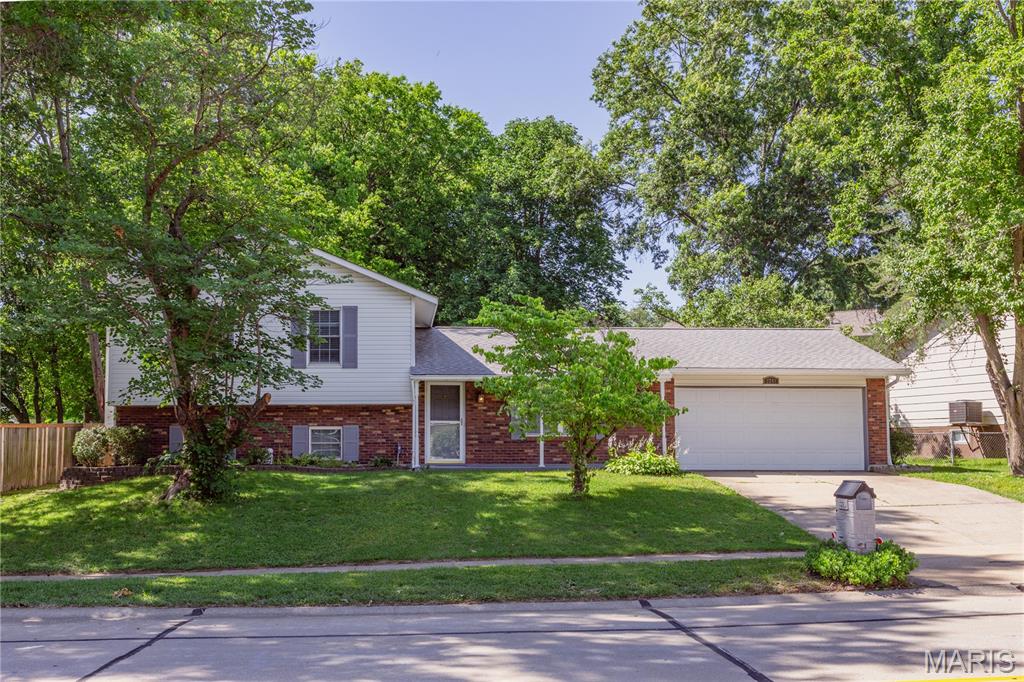 Welcome to this beautiful and spacious multi-level home designed with comfort, functionality, and everyday living in mind. Offering 4 bedrooms and 3 full bathrooms, this well-maintained home provides plenty of space for families of all sizes.
The lower-level family room features rich hardwood floors and a cozy fireplace, creating the perfect gathering space for relaxing or entertaining. Upstairs, you'll find the private primary suite complete with its own full bathroom, along with two additional bedrooms and a centrally located full bath. The main level offers a bright and inviting living room, a large kitchen with ample workspace, and a dining area ideal for family meals and entertaining. Just off the dining area, step into the screened-in sun porch and enjoy views of the large backyard, which backs to mature trees for added privacy, shade and a peaceful setting. A fourth bedroom and full bathroom are located just five steps down from the main level, making this area ideal for a teenager, college student, guest quarters, or a private home office. Additional highlights include an oversized 2-car garage, large driveway, mature shade trees and beautifully landscaped yard. The roof was replaced in 2016. 
One Year Home Warranty is provided by the Sellers for the Buyers first 12 months.
Conveniently located in the highly regarded Francis Howell North School District within the City of St. Charles, this home offers easy access to major highways, shopping, dining, and everyday amenities. Combining space, versatility, and an excellent location, this is a home you'll be proud to call your own.