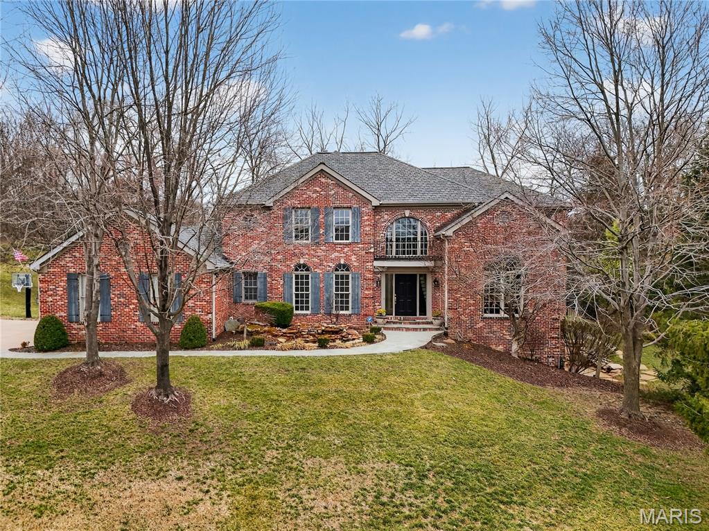 Live your vacation every day in this retreat that offers luxury, comfort, and resort-style amenities—without ever leaving home. The outdoor haven features a beautifully landscaped pool with rock waterfall, outdoor fireplace, and a fully equipped outdoor kitchen—perfect for entertaining or quiet evenings at home.  Enjoy architectural details throughout, including crown molding, vaulted and coffered ceilings with cove lighting, custom built-in bookcases, a Sonos whole-home audio system, and expansive floor-to-ceiling windows that fill the home with natural light. Inside, a 2-story foyer opens to the impressive 2-story living room with floor-to-ceiling fireplace and windows. The chef’s kitchen boasts a center island, stainless steel appliances, a large walk-in pantry, and an eat-in area that flows into the cozy hearth room—ideal for chilly nights. The main-floor primary suite is a true sanctuary, offering 2 separate walk-in closets and a spa-like ensuite bath with double vanity, separate shower, and jetted tub. The remainder of the main level includes a dedicated office, formal dining room, and convenient laundry room. Upstairs, you’ll find three generously sized bedrooms, all with walk-in closets. One features a private ensuite bath, while the other two share a Jack-and-Jill bath. The walkout lower level is made for entertaining, with a spacious family room featuring a fireplace and new carpet, a dining area, and a wine room. This level also includes a 5th bedroom, full bath, mirrored exercise room, and a large unfinished storage area. Additional highlights include 3-zone HVAC, 2 hot water heaters, a water softener, and a 3-car garage—ensuring comfort, efficiency, and ample storage. This exceptional home combines everyday livability with resort-style luxury. Welcome home to your private getaway.
