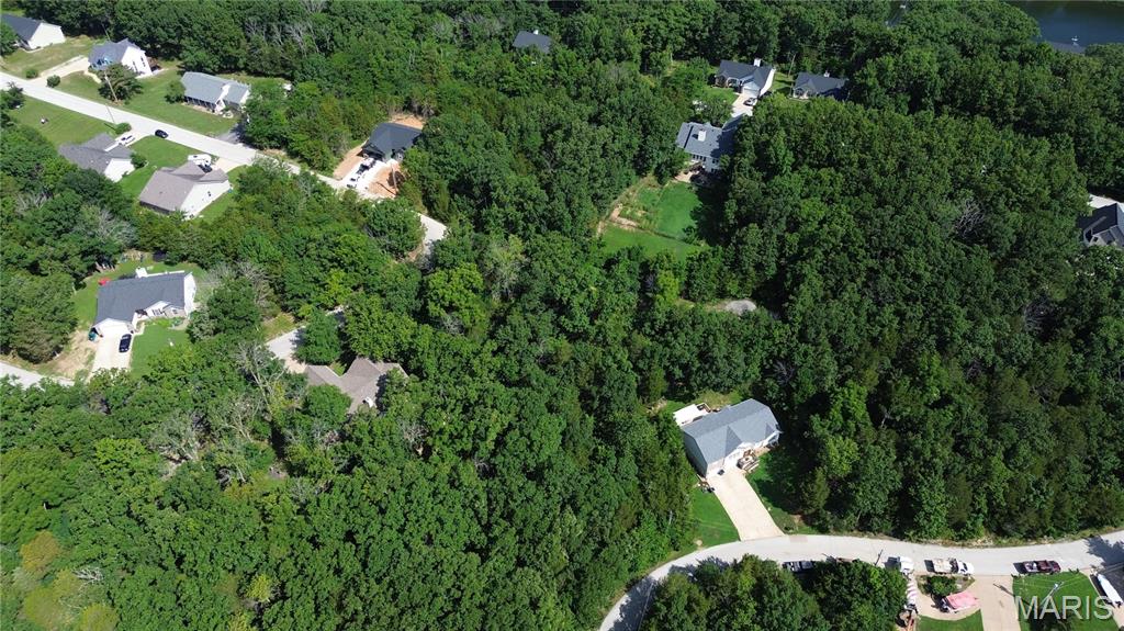 Right down from the BIG LAKE! Buy as an individual lot for lake access or check out the neighboring lots to purchase as a package and save, save, save! These ready-to-build home sites are located in this private, gated, resort-style community with 3 lakes, golf course, campgrounds and more. Perfect for builders to market to anyone seeking a peaceful, recreational lifestyle away from St. Louis, but still very close for easy family visits. Also perfect for "get-away" lake home. Enjoy the golf course, lake, boating, fishing, clubhouse, pool, etc. ! Just 20 minutes from South County!