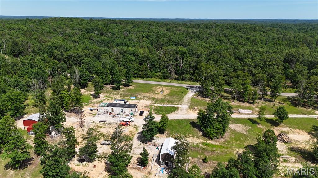 This is a sleeper - 2 homes under construction and needing some work on 20 Acres with multiple camp sites (3 with water and electric already set-up) Trails for Side-by-sides and 4 wheelers for wilderness wandering and off-grid camping. Multiple ponds and area for deer and turkey to feel at home. It has been reported, this is the best deer hunting area locally. Jadwin, Missouri, situated right in the heart of the Ozark National Scenic Riverways, is a premier destination for floating, trout fishing, horseback riding, and ATV trail riding. The crystal-clear Current river and surrounding Mark Twain National Forest serve as the perfect basecamp for following outdoor recreation options: hiking and floating, canoe, kayak, and rafting, and tube down the spring-fed waters.  Nearby is the Echo Bluff State Park and Montauk State Park. What an opportunity to have your own Airbnb and camp-site for year-around fun. Don't miss out on this, call to make your appointment to view this special property.
