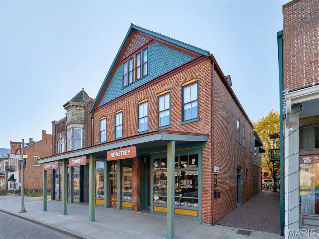 214 E 1st Street is situated directly on Hermann’s main drag, and this property offers a rare opportunity to purchase an impeccable building along with the fully operational Stomp’n Grounds Espresso Bar and Half Corked Inn guest suites, all in the heart of one of Missouri’s most visited and admired communities. Commonly crowned as “Missouri’s Most Beautiful Town,” 214 E 1st Street sits in the center of Hermann’s primary commercial corridor, steps from wineries, breweries, restaurants, shops, trolley service, and the Amtrak station. The 3-story, 4,800 sq ft building is exceptionally well maintained, with updated mechanical systems and modernized interiors, while still cherishing the historic quality and character of this impressive property. From the massive picture windows in the cafe, the solid brick construction, reclaimed floors, and beautiful renovations, to the high-end cafe, fixtures, organized service areas, and welcoming courtyard, continued investment and care stand out at every turn.

The ground floor is home to Stomp’n Grounds Espresso Bar, an anchor of Hermann and a fully functioning café business included in the sale. The café interior is clean, modern, and thoughtfully laid out, featuring quality in everything from the newer LaMarzocco espresso machine, Simonelli espresso grinders, on-site coffee roaster, copper counters, stainless commercial-grade kitchen equipment, and welcoming seating areas, and a beautiful patio that make for a great customer experience and efficient investment. The brand has an established following, supported by its strong street visibility, consistent tourist foot traffic, and online presence. Stomp’n Grounds operates with full-time employees and defined operational systems, allowing the business to run without an owner needing to handle day-to-day oversight. The business conveys with its equipment, inventories, menu infrastructure, POS, branding, online presence, and all components necessary for a seamless transition. The seller will assist in the transition and training of new owners.

Half Corked Inn consists of two short-term rentals above the cafe;. Silver Moon Loft is a cozy, private short-term rental with a warm, comfortable atmosphere and an efficient, welcoming layout. The loft includes a fully equipped kitchen, dining room, a well-appointed bedroom, an upgraded bathroom, a fireplace, a smart TV, a washer/dryer, and everything guests would need. Guests enjoy access to the courtyard and firepit, along with breakfast coupons for the cafe; below, which provide convenience and enhance their overall experience.

The neighboring Harvest Hills Loft is a 2-story, larger short-term rental designed for groups, featuring three bedrooms. Two full bathrooms and a private washer/dryer make the space practical for larger groups, and the open living area includes a fireplace, smart TV, and a comfortable seating layout. The kitchen is fully equipped with essentials for more extended stays, and a private desk and reading area provide guests with a quiet place to work or relax. The private balcony overlooks the courtyard, creating a peaceful spot and room to spread out. The unit is clean, well arranged, and stocked with coffee, tea, and bottled water, along with breakfast coupons for Stomp’n Grounds. With nearly 500 5-Star reviews and future reservations already booked, these units are an easy transition with immediate cash flow for the next owner.

Taken together, 214 E 1st Street represents a truly turn-key investment with multiple established revenue streams. The cafe is staffed and operates efficiently, while the 2 short-term rentals are furnished and fully functional. The building’s location and income potential make it a standout property in one of Missouri’s most desirable tourism markets. 
This is a duplicate listing to MLS #25077815.