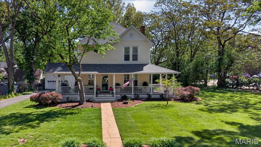 Welcome to 108 North Old Orchard, a stunning American Four-Square farmhouse (circa 1889) in the heart of Webster Groves. Thoughtfully restored and renovated inside and out, this home beautifully blends historic charm with modern functionality. The inviting wrap-around front porch sets the stage for relaxed living and effortless entertaining. Inside, a spacious foyer with the original staircase opens to a light-filled living room featuring a cozy gas fireplace. A two-story addition offers a generous eat-in kitchen with ample space for gathering, along with a butler’s pantry and mudroom. Step outside to enjoy the deck, covered porch, and private backyard retreat. Upstairs, the primary suite is a true sanctuary, complete with a private office, laundry, two large walk-in closets, and a spa-like bath. Two additional bedrooms and two full baths provide plenty of space on the second floor, while the third floor offers a versatile fourth bedroom. Don’t miss the detached two-car garage with a carriage house above, featuring a full bath—ideal for a guest suite, home gym, or media room. With over 3,500 square feet of living space, this home offers both room to spread out and a warm, inviting feel. Additional highlights include a new roof (2026) and an unbeatable location just steps from Frisco, Balkan Treat Box, and the wonderful shops of Old Orchard. This home truly has it all!