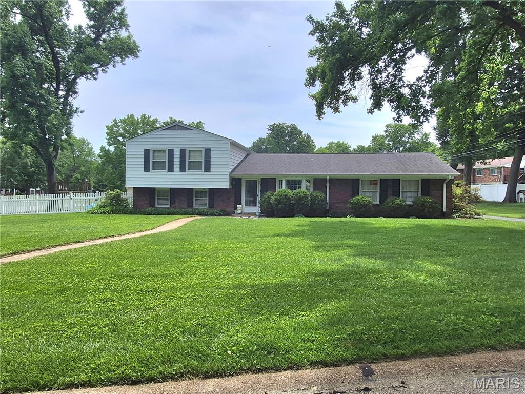 Welcome to this beautifully maintained 3-bedroom, 2-bathroom home situated on a desirable corner lot in Cherry Hills subdivision.  The primary bedroom boasts its own bath that was previously updated and hardwood flooring. Bedroom 2 and 3 also have hardwood flooring and the main bathroom was previously updated..  The living room and dining room are very inviting with hardwood flooring throughout and large picture windows for plenty of light, this home combines comfort, style, and functionality  The kitchen features oak cabinets, stainless steel appliances, and ceramic tile flooring, with a lovely view of the outdoor patio and fully fenced backyard—perfect for entertaining, relaxing, or enjoying outdoor activities. The lower level partially finished basement with a fireplace is great for a recreational area and unfinished storage area with laundry area.  The home's thoughtful layout provides comfortable living spaces filled with natural light. Conveniently located within walking distance of an elementary school and neighborhood park, this property offers an ideal setting for families and anyone seeking a welcoming community. Don't miss the opportunity to make this charming, move-in-ready home your own.