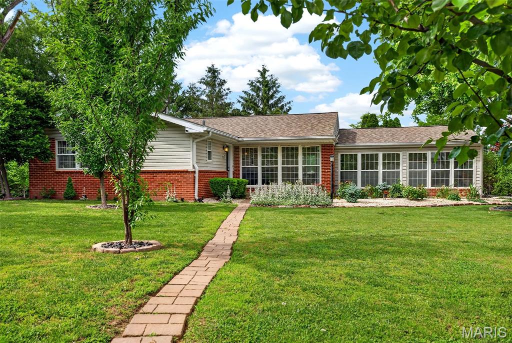 Buyer walked after inspections. Crack was found in city main.  Seller is working with Olivette now to remedy. Brick ranch in the Ladue School District sitting on .682 acres in Olivette, Missouri with 3 bedrooms, 2.5 bathrooms, a finished basement, and a sunroom. This is an exceptional opportunity to enter one of the most sought-after school districts in the St. Louis Metro Area. The main level features hardwood floors throughout the living room, dining room, and bedrooms, a kitchen with white cabinetry, subway tile backsplash, stainless steel appliances, and tile flooring, and a bright sunroom with wraparound windows, exposed brick accent wall, ceiling fan, and direct access to the backyard. The brand new wood deck with white vinyl railing sits off the dining room and overlooks a mature, tree-lined yard. The finished basement includes a family room with luxury vinyl plank flooring and recessed lighting, a bonus room ideal for a guest bedroom or home office, and a half bath with a glass vessel sink. The primary bedroom connects to a private bath with a walk-in shower featuring white subway tile surround and mosaic tile floor. A full hall bath with pedestal sink, brushed gold faucet, and tub/shower combo serves the additional bedrooms. The .682-acre lot is surrounded by mature trees, fruit trees with landscape lighting, a flagstone patio with fire pit, and a hammock grove creating exceptional outdoor privacy. Side-entry attached one car garage with paved driveway. Located minutes from Interstate 170, Olive Boulevard dining and retail, Costco, Target, and Dierbergs. Turnkey ranch living in the Ladue School District in Olivette, Missouri.