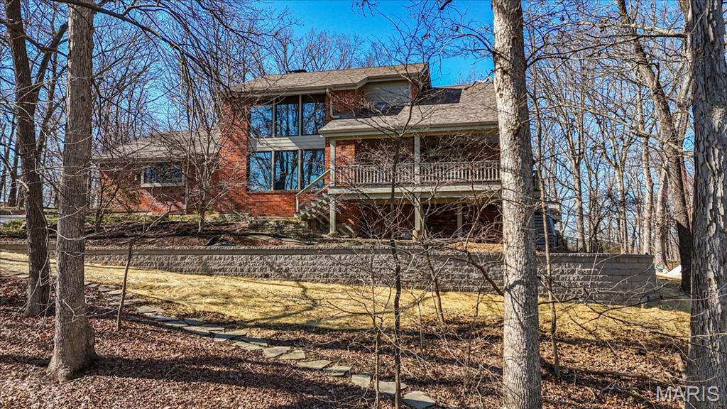 Back on the market! No fault of the sellers! If you missed it the first time, you have another chance to view 1645 Trotting Trail Road, an exceptional estate set on 2 private, picturesque acres in the heart of Clarkson Valley in Kehrs Mill Trails Subdivision. With over 4,900 square feet of thoughtfully designed living space, this residence offers a refined blend of luxury, comfort, and effortless indoor-outdoor living. Featuring 4 spacious bedrooms and 3.5 beautifully appointed bathrooms, every detail has been carefully curated. A dramatic two-story entry and great room create an immediate sense of scale and elegance, anchored by a beautifully renovated open custom staircase with wrought iron spindles. Solid hardwood floors flow seamlessly throughout the main living areas, adding warmth and sophistication. The renovated kitchen is a true showpiece, featuring custom cabinetry and high-end appliances including a 6-burner Wolf gas range and built-in refrigerator—perfectly suited for both everyday living and elevated entertaining. The main-floor primary suite serves as a serene retreat, complete with a spa-inspired ensuite featuring dual vanities and a generous walk-in closet. Just beyond, step directly outside to your own resort-style oasis—where the pool and hot tub are only steps away, creating a seamless connection between indoor comfort and outdoor luxury. Designed for both relaxation and privacy, the outdoor spaces are truly exceptional. Mature trees and expansive grounds provide a sense of seclusion, while the sparkling in-ground gunite pool and hot tub offer a tranquil setting reminiscent of a private resort. At the front of the home, a spacious covered deck invites quiet mornings with a cup of coffee and peaceful views of the neighborhood lake—an idyllic place to begin or end your day. The finished lower level further enhances the home’s lifestyle appeal, featuring an additional sleeping area, a dedicated fitness space, and a full bath complete with a steam shower—perfect for unwinding after a workout or creating your own in-home wellness retreat. For those seeking a touch of charm and self-sufficiency, the backyard chicken coop offers a unique farm-to-table experience with fresh eggs and a bit of country living—without sacrificing luxury. A rare opportunity to experience privacy, luxury, and lifestyle—all just minutes from everything Chesterfield Valley has to offer in award-winning Rockwood School District.