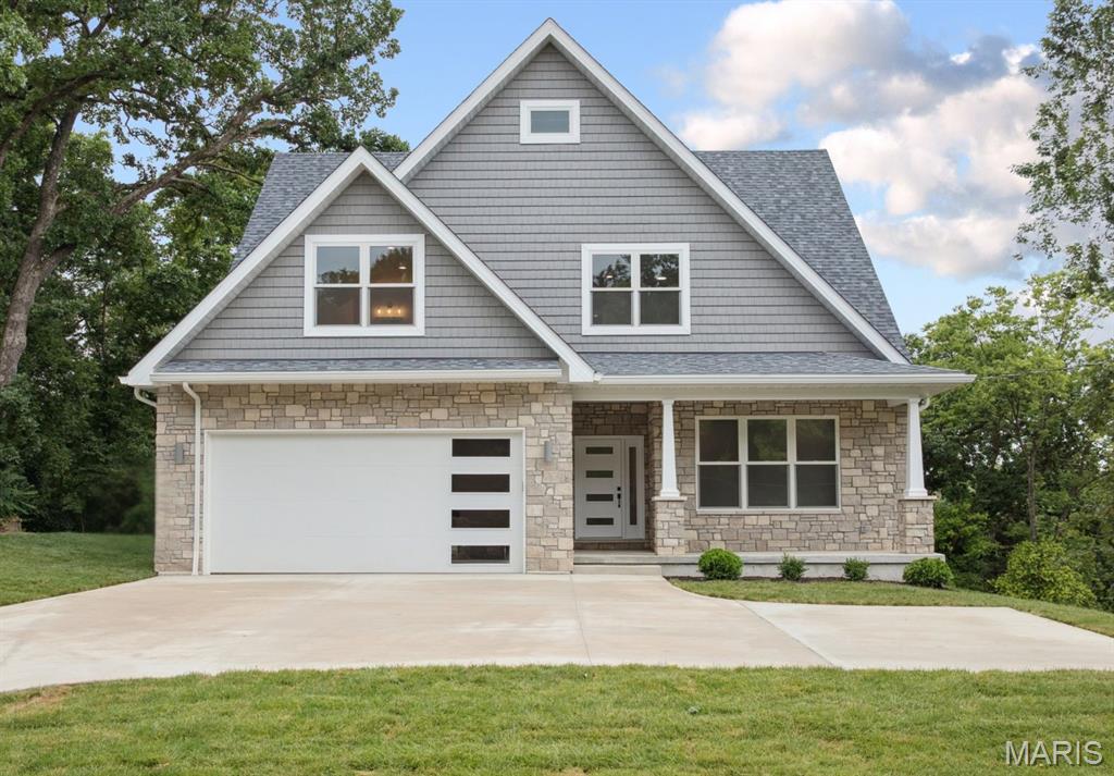 Welcome to this thoughtfully designed custom new construction home offering rare flexibility and elevated finishes in Sunset Hills and the Lindbergh School District. With two primary suites, two laundry rooms, and multiple living areas across three finished levels, this home delivers a layout that’s as smart as it is stylish. 
The sun-filled main level features hardwood floors, crown molding, a private office, and an open-concept living area anchored by a sleek marble-slab gas fireplace. The show-stopping kitchen pairs beauty and function with quartz countertops, high-end appliances, a waterfall island with built-in microwave, pantry, and a built-in buffet with beverage cooler. A window-lined dining area opens directly to the back deck, creating an ideal setup for entertaining.
A highly sought-after main-floor primary suite offers a true retreat with heated marble bathroom floors, soaking tub, separate shower, double vanity, and custom walk-in closet. A floor-to-ceiling tiled powder room and spacious mudroom with main-floor laundry complete the level.
Upstairs, a generous loft provides flexible living ideal for work, play, or relaxation. The second primary suite features a spa-worthy bath with heated floors, soaking tub, and oversized shower. Two additional bedrooms, a full bath, and a second laundry room complete the upper level.
The finished walk-out lower level includes tall ceilings, a large rec area with wet bar, plus a bedroom with egress window and full bath. Exceptional storage throughout.
A refined blend of comfort, flexibility, and elevated design in a prime Sunset Hills location.