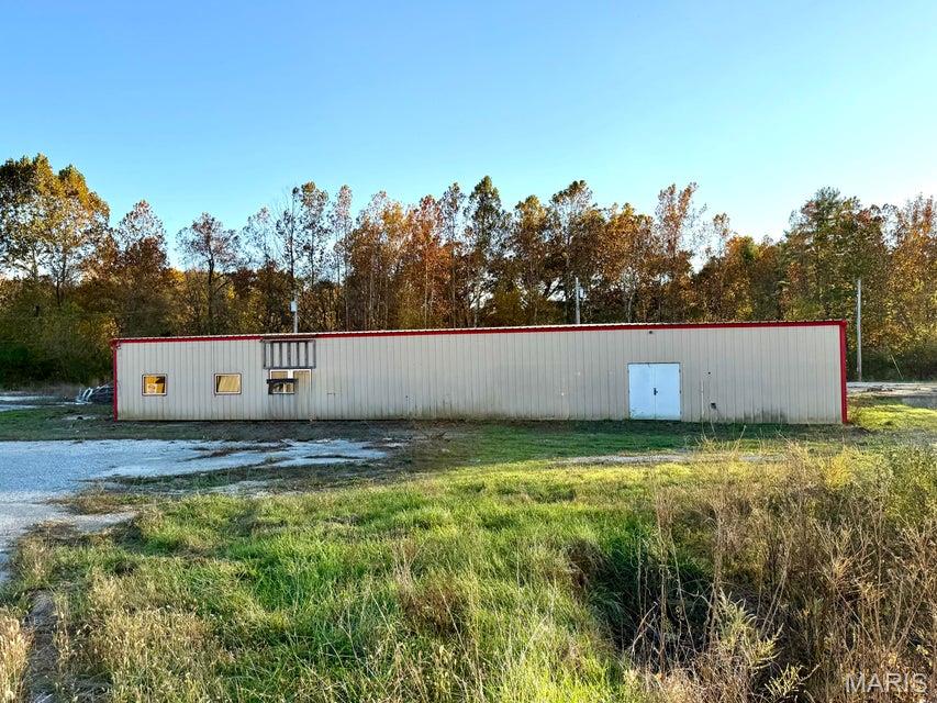 2.7 acre Commercial Property located at the intersection of Hwy 63 and Hwy B in Houston, Missouri. High visibility location with easy access. 10,000 sq ft metal building with spray foam insulation, concrete floor, city utilities, open ware house space, wood paneled offices and restrooms. Some TLC needed to exterior. 45 minutes to Rolla, 90 minutes to Springfield and 2 1/2 hour to St. Louis.