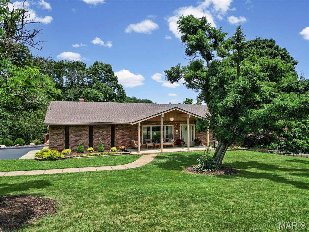 You don't want to miss this, it hasn't hit the market for 37 years! Welcome home to this spacious 3 bedroom, 3 full bath home situated on a little over 3.5 acres of beautiful, usable land. If you’ve been looking for a home that offers space, privacy, and a peaceful setting without being too far from everyday conveniences, this is it. Inside, you’ll find an open floor plan as soon as you step in the door, windows creating abundant lighting a separate formal living/dining room and a family room at the rear of the home. The kitchen on the main level offers abundant cabinet space including a large island with additional sink, buffet counter space perfect for gatherings and a snack bar! Enjoy the charming bay window overlooking the backyard and surrounding woods. It opens directly to the family room, where a wood-burning fireplace creates the perfect place to gather and unwind. Step outside onto the large deck and enjoy the quiet surroundings and scenic views. The backyard offers a wonderful mix of open, usable space and mature trees, with plenty of room for children, pets, gardening, outdoor entertaining, or simply enjoying nature. With acres of woods behind the home, wildlife and peaceful views become part of your everyday surroundings. The fully finished walk-out lower level adds even more room to spread out. It features a second kitchen with appliances, a full bathroom, additional sleeping rooms or office spaces, plenty of storage, and direct access to the backyard patio and built-in fire pit. Whether you need space for extended family, overnight guests, working from home, hobbies, or a recreation area, this level offers plenty of flexibility. Additional features include a spacious garage, an extra-wide driveway for plenty of parking, two raised garden beds, a functional wood-burning furnace, and a new roof installed in Spring 2026. Come home, slow down, and enjoy the space, privacy, and peaceful backyard this property has to offer. Schedule your tour today!