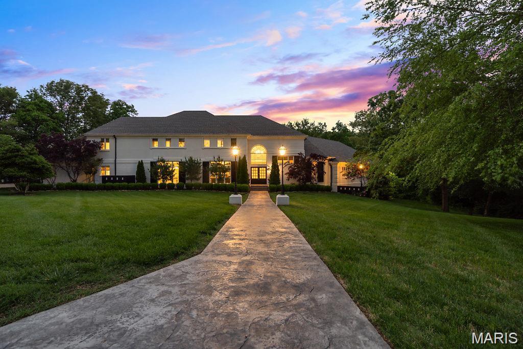 Tucked away on 1.5 pristine acres at the end of a quiet cul-de-sac, this breathtaking 12,000+ sq ft architectural masterpiece is the definition of a showstopper! Designed for grand entertaining, refined everyday living, and unforgettable memories.
From the moment you arrive, the scale and elegance are undeniable. Inside, a chef’s dream kitchen anchors the home, complete with a butler’s pantry and eat-in kitchen. Both formal living and dining rooms set the stage for timeless entertaining, while the dramatic two-story family room steals the show with soaring ceilings and a stunning new stone fireplace. 
The primary suite is a private retreat, featuring French doors leading to a dedicated office, a massive walk-in closet with center island, and in-suite laundry, all worthy of a luxury hotel. High-end lighting, exquisite trim-work, designer wallpaper, and fine craftsmanship truly define this home. 
Bring entertaining to a new level and check out the state-of-the-art movie theater room to elevate nights at home. Step out from main level into a resort-style outdoor oasis designed for year-round enjoyment: In-ground pool, outdoor fireplace, hot tub, expansive deck surrounded by mature trees and privacy.
Every detail of this estate was curated to impress, grand in scale, flawless in function, and unforgettable in presence.