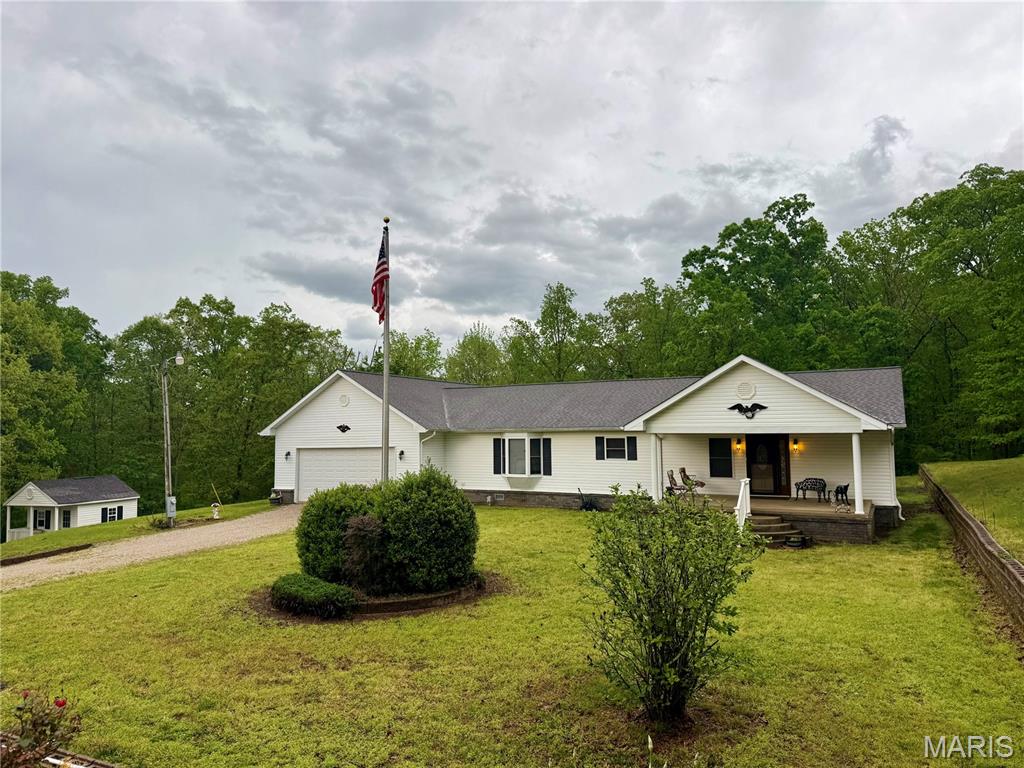 Escape to Wayne County with this well maintained three bedroom, three bathroom home. Set on a 1.13 acre lot 6 miles north of the Wappapello dam, this property is a perfect gateway to lake life and the outdoors. The home features 1,678 square feet of open concept living space with vaulted ceilings and recessed lighting. It can also be purchased fully furnished, making it a great turnkey vacation retreat or easy primary residence.
The highlight of the home is the private, screened in back patio. It offers a peaceful, bug free spot to enjoy views of the heavily wooded area adjoining the property. Inside, you will find a cozy family room with an electric fireplace, a functional kitchen and dining combo, and laminate flooring throughout most of the main areas.
Ample storage is provided by a massive 35 by 25 attached two car garage and an additional shed. Located in the Holiday Hills development, you are just down the road from Mingo National Wildlife Refuge and minutes from the fishing and boating at Lake Wappapello. This property offers the perfect balance of quiet country living and easy access to recreation.