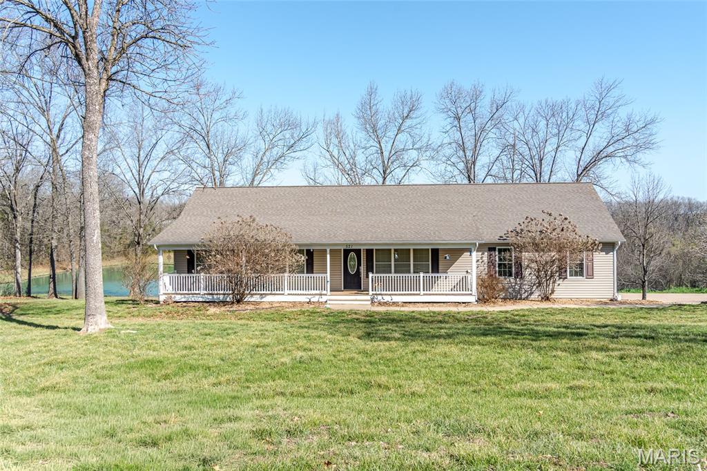 This place has it ALL!!! 6+ acres, beautiful lake, large outbuilding, beautiful ranch home just MINUTES to town! Home features warm wood floors throughout, 2 nice sized bedrooms, and a large primary bedroom with spacious closets, soaker tub has picture window overlooking your stunning lake view! Kitchen is great for hosting with large kitchen island and walks out to screened deck. SUNSETS over the water are STUNNING! Lower level is finished with living/rec room, bedroom, office area, and full bath. Opportunities like this do not come often! Schedule your private tour today!