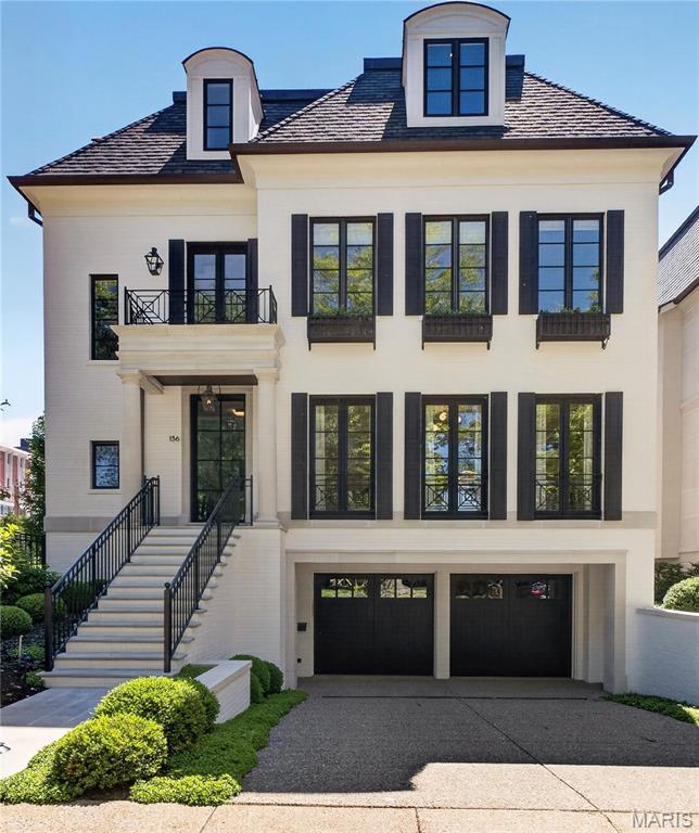 Experience elevated living in this exemplary residence in the heart of Clayton, just minutes from dining, shopping and the business district. Situated on .27 acres, the property offers an exceptional amount of outdoor space in one of Clayton's most desirable locations. Designed and built by Slavin Homes, this four-bedroom, three-story home showcases exceptional craftsmanship and thoughtful attention to detail throughout; with custom millwork, hardwood flooring, custom cabinetry, and finishes that blend luxury with everyday livability.

The top-of-the-line Kitchen, appointed with premium appliances and every modern amenity, flows seamlessly into the Hearth Room, Breakfast Room, Bar Area, and open Porch; creating inviting gathering spaces ideal for both daily living and entertaining. The Living Room and Dining Room offer the ultimate in sophistication, and provide the perfect backdrop for elegant dinners and special occasions. The home features 10-foot ceilings on the main and second levels, while expansive windows fill the interiors with abundant natural light. The Primary Suite serves as a private retreat with a luxurious bath and two spacious walk-in closets, while the additional second-floor bedrooms each offer en suite baths.

The third floor adds exceptional flexibility with 9-foot ceilings, a large multipurpose room, fourth bedroom, and two additional baths. The lower level includes a finished living area, half bath, and walnut wine cellar ideal for collectors and entertaining, along with ample unfinished storage space. Additional highlights include a rare four-car garage, elevator, and outdoor living area with a fireplace that opens to the spacious back and side yards. Situated on a beautifully landscaped lot, the property offers an expansive outdoor setting rarely found in this area of Clayton.

Included in the sale is 140 N. Brentwood an additional .139 acres, further enhancing the privacy, outdoor space, and overall setting of this rare offering in the heart of Clayton.